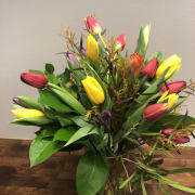 Tiptoe Through the Tulips - 2 dozen Tulips (or more!) - 24 assorted tulips herald the arrival of the season, beautifully designed in a lovely vase. The fullness of the high quality tulips needs no additional frills. Color assortment will vary, and will include at least 3 colors of tulips. For additional colors and even more blooms, check out the Deluxe (36 tulips) and Premium (50 tulips!) upgrades.  Vase may vary from what is pictured.