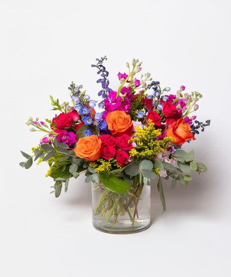 Pick-Me-Up Petals - This floral arrangement is a vibrant and energetic mix of bold colors and textures, featuring a combination of several popular blooms.