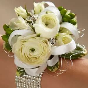 White Ranunculus and roses Corsage - White ranunculus and spray roses are brought together with green hypericum berries 