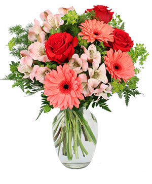 Bouquet of red roses, pink gerbera daisies, and pale alstroemeria in a glass vase