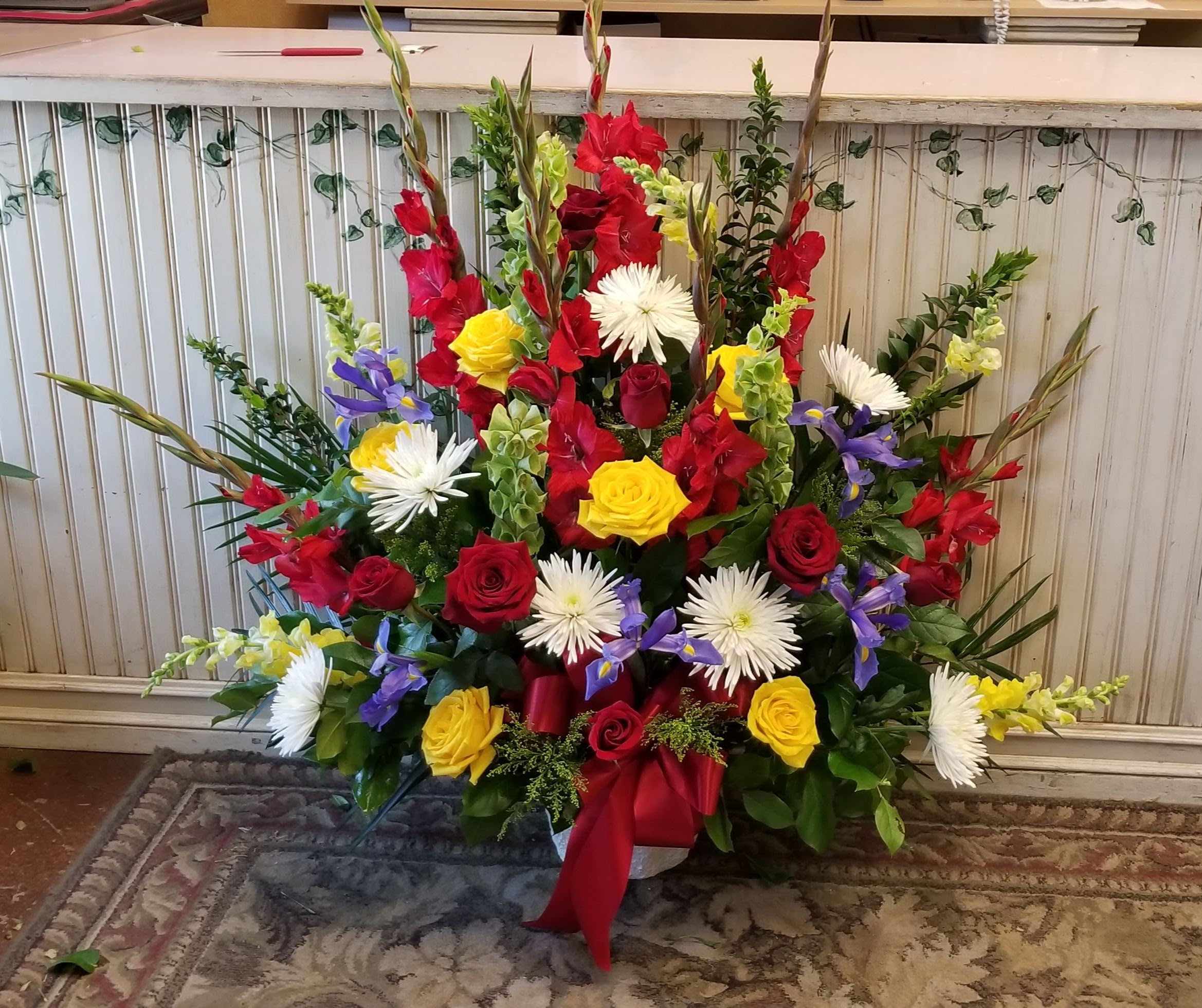 Tall mixed bouquet with red, yellow, white, and purple flowers