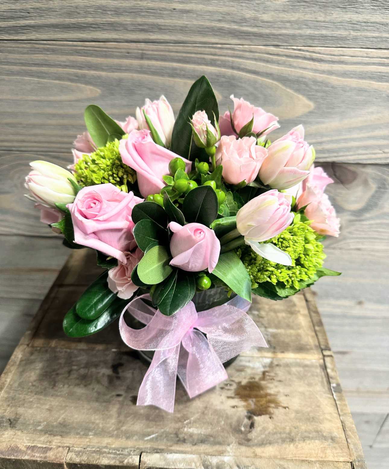 Dream - This beautiful and elegant collection of light pink roses and tulips with mini green hydrangeas and berries with a simple chiffon bow is a must have gift for any special someone.