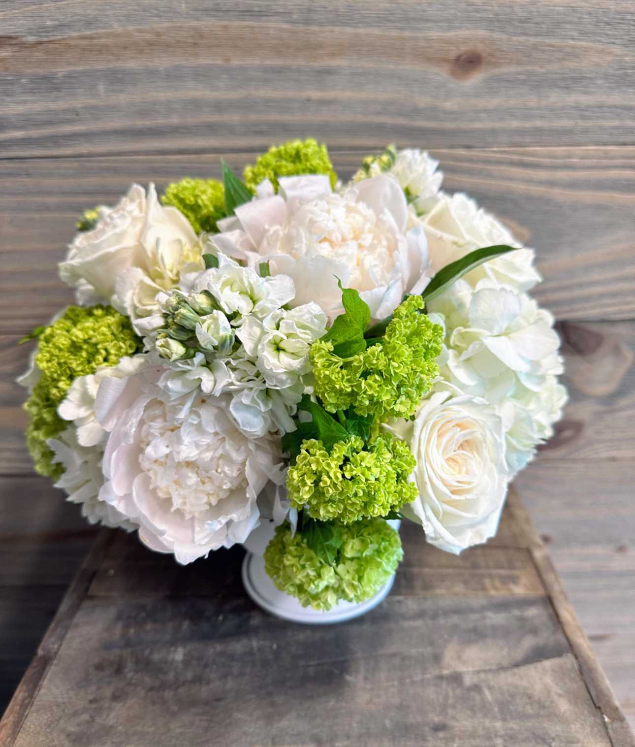 Park Avenue Princess - A beautiful arrangement of white and green spring flowers in our signature white Sidney urn.