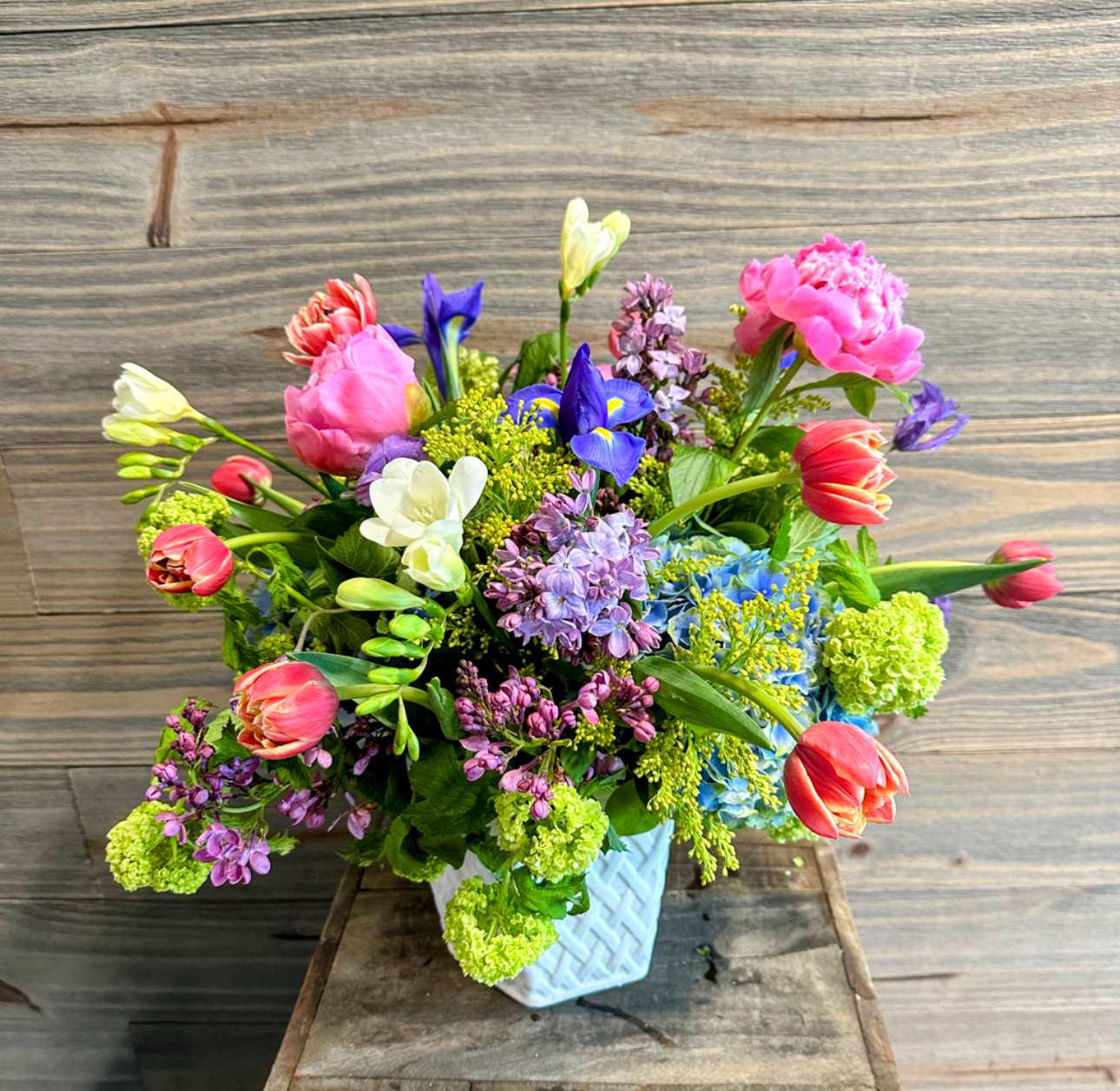 Garden Bouquet - A large white ceramic container with a spring garden mix of colorful blooms!