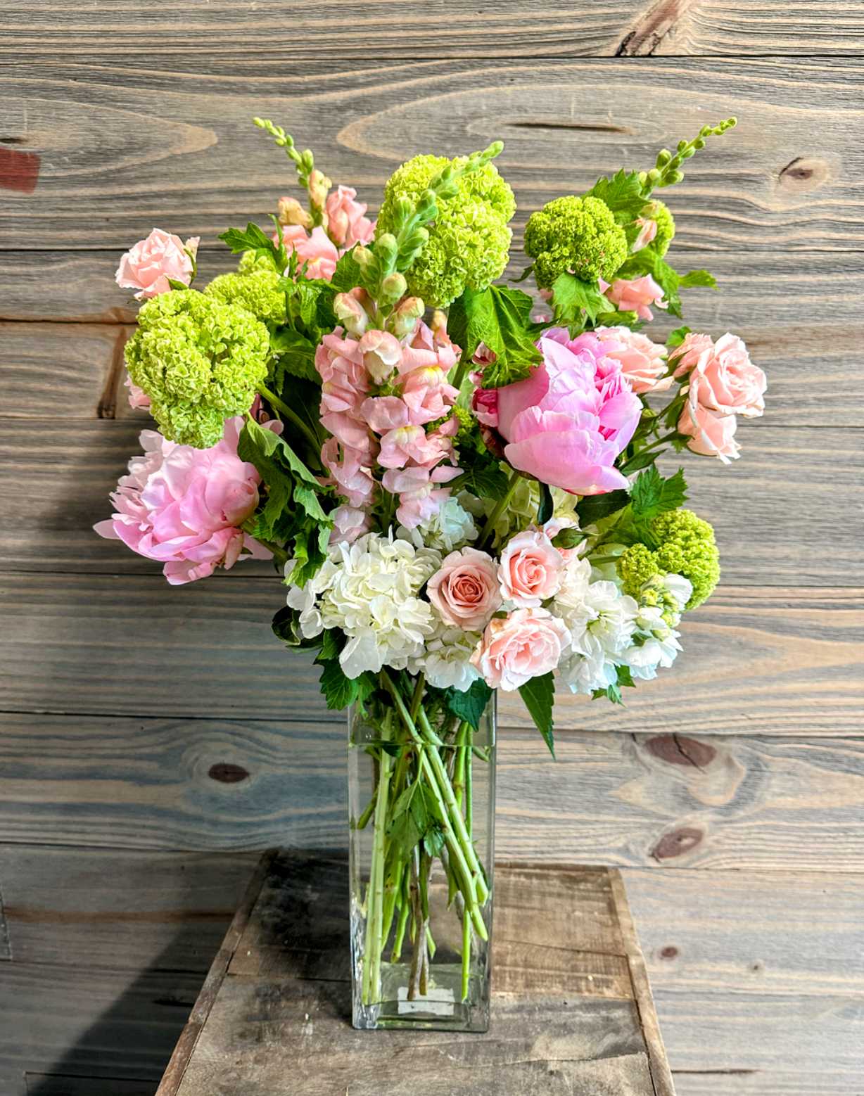 Juliet Bouquet - A tall vase of pinks and white spring blooms including hydrangeas, spray roses and peonies.