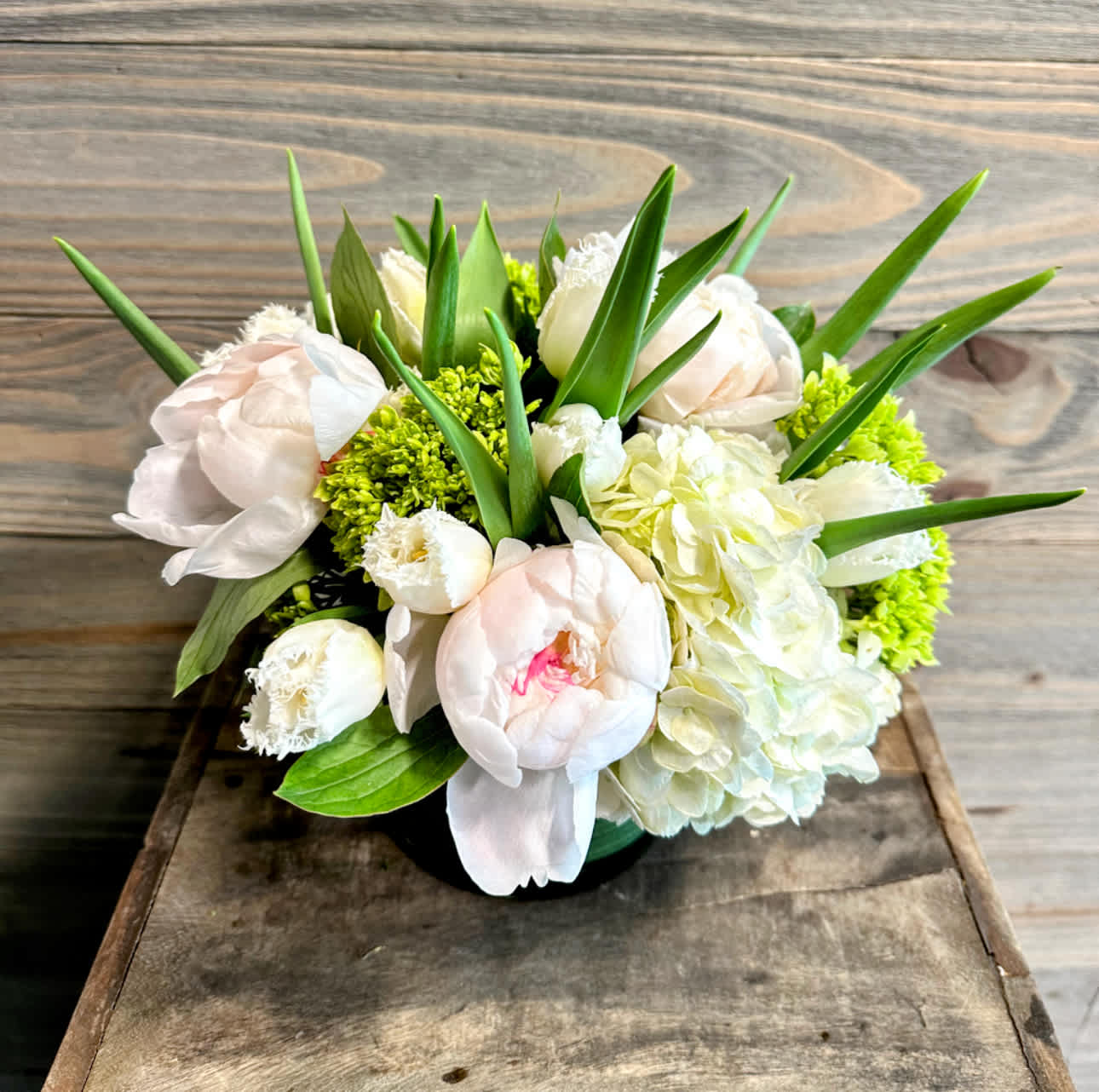 Crescent Spring - A simple but elegant bouquet of bright white peonies, hydrangeas, tulips etc,