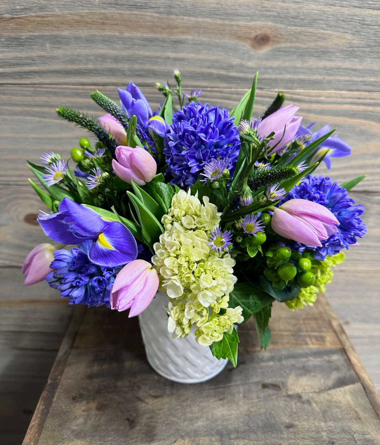 Bouquet of purple and pink flowers in a white vase