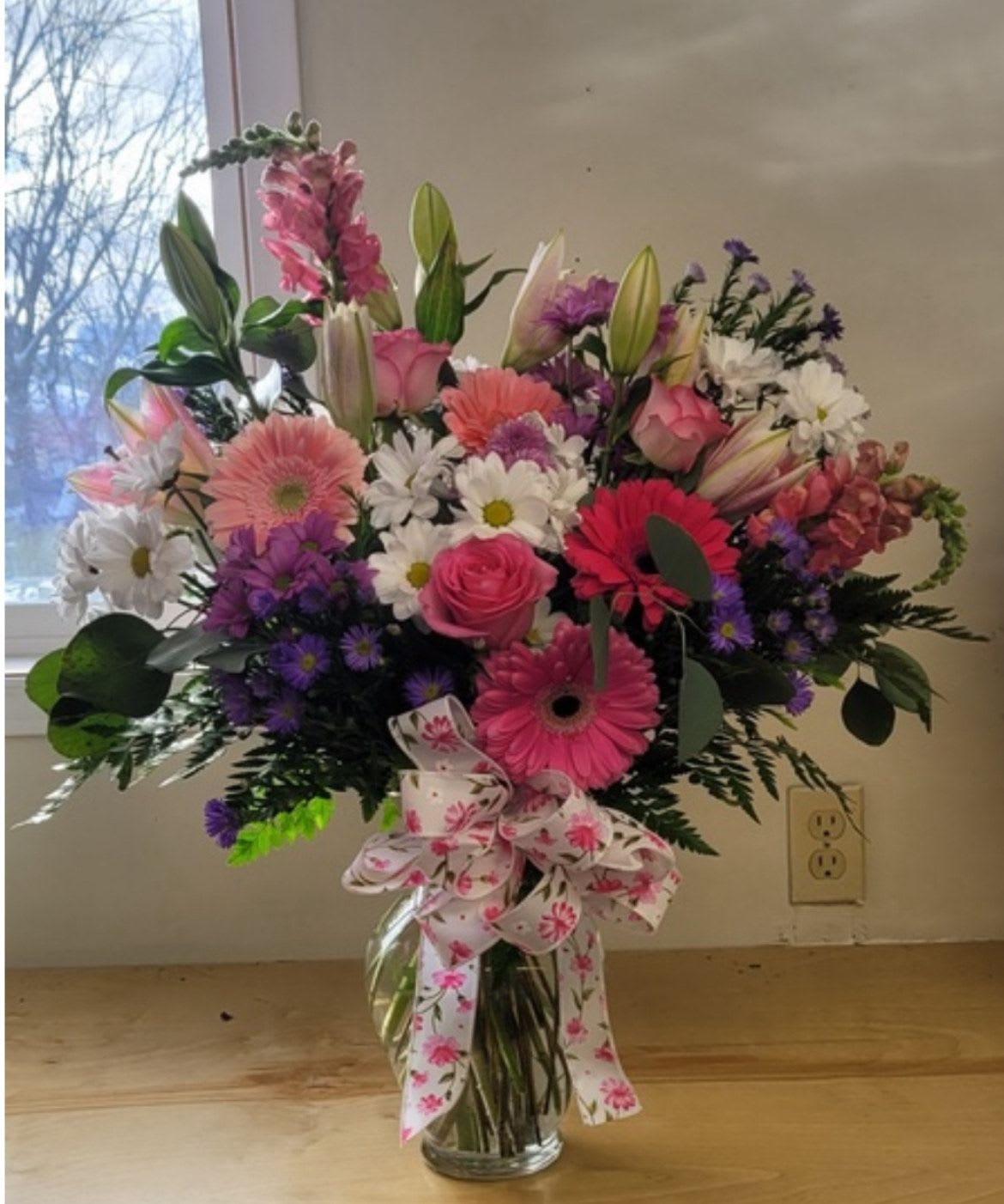 Be Mine by Lotherington's - If your partner's love language is gifts, don't sweat it. This classic (and big!) arrangement is a perfect way to celebrate and show your love. Whether it be Valentine's Day, an anniversary, or a random Tuesday, this arrangement will be sure to wow.  Approximate Dimensions: 20"D x 25"H