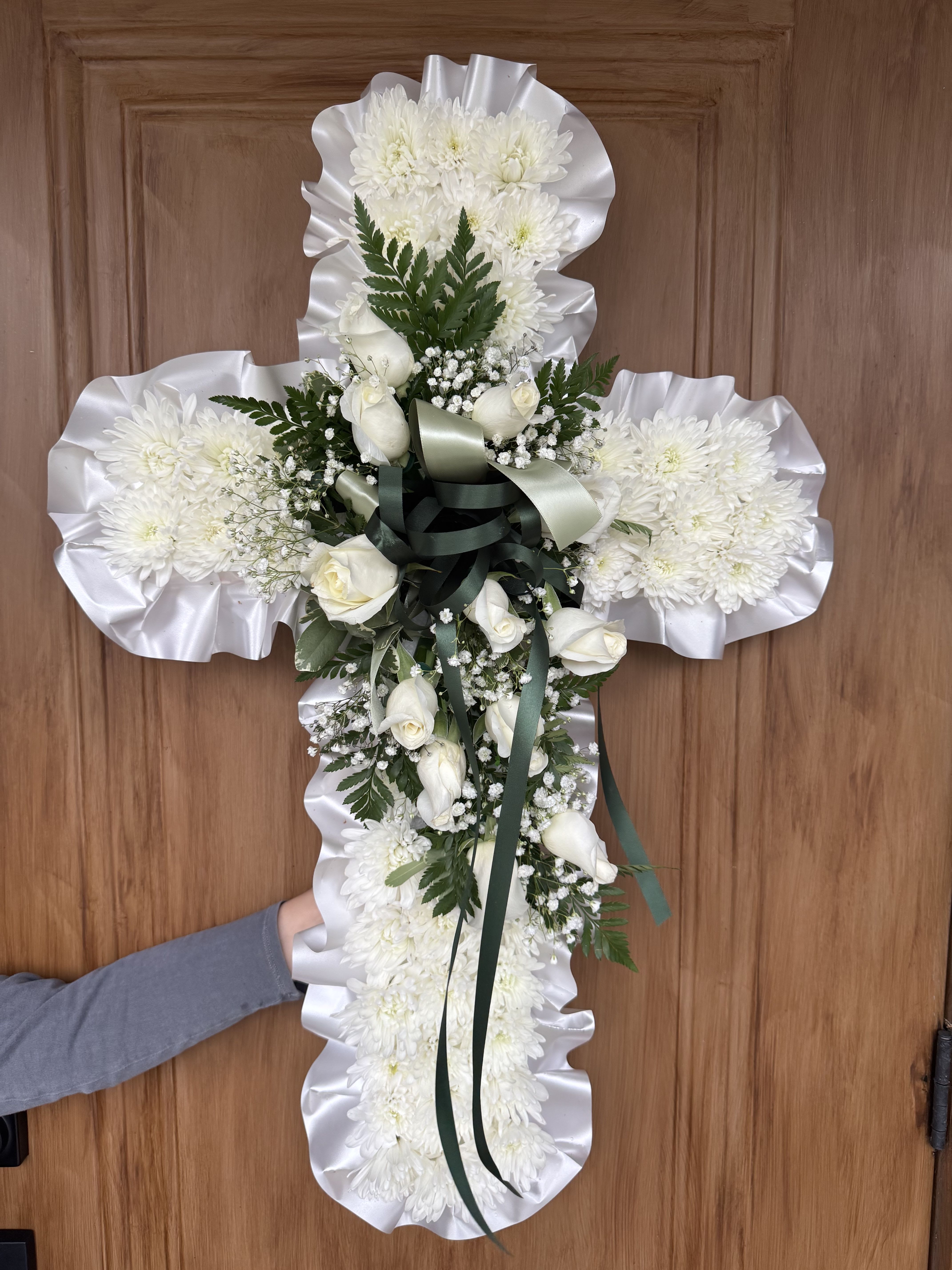 Faith by Lotherington's - An all white tribute, this white cross funeral spray is pure and tranquil. Standard size features white chrysanthemums.  Deluxe features a mix of white chrysanthemums and white roses and the Premium sizes features all white roses this elegant easel compliments the beauty of life. 