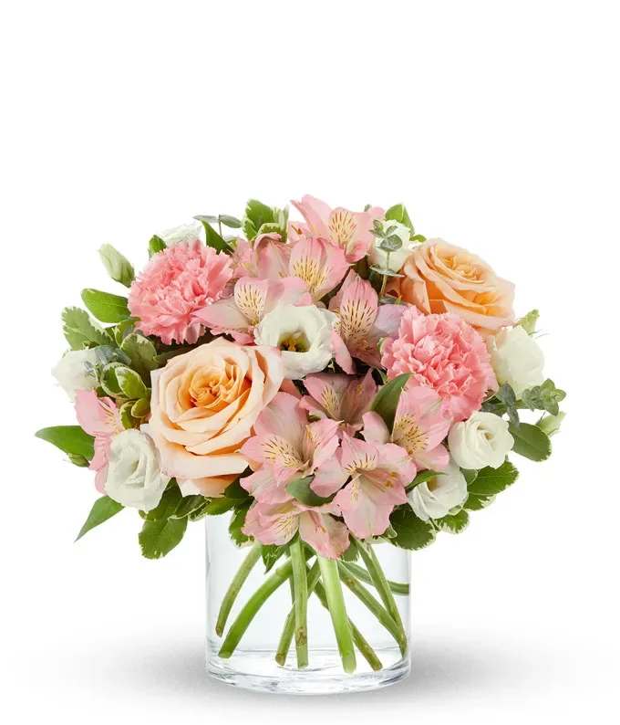Pink and peach bouquet in a clear glass vase