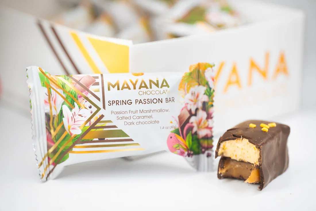 Mayana Spring Passion Bar - Description:  Decadent salted caramel is layered with a brightly flavored passionfruit marshmallow. Let your thoughts shift to warm weather with every bite of our Spring Passion bar.  Contains: Milk, Soy.  May contain: Traces of tree nuts, peanuts, wheat &amp; egg