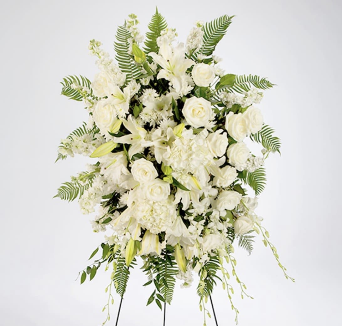 True Sympathy - An all white tribute, this funeral spray is pure and tranquil. Featuring a variety of white flowers and green palms this elegant funeral spray brings a feeling of peace to its surroundings  REQUIRES 3-5 DAYS LEADTIME. Please contact shop if shorter leadtime is needed.