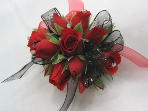 Red rose corsage with black ribbon and clear gems