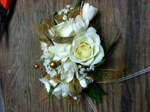 White rose and daisy bouquet with gold ribbon accents