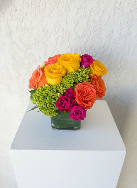 Sunset Pop - A vibrant mix of bright roses and seasonal blooms designed to bring bold color and joy.