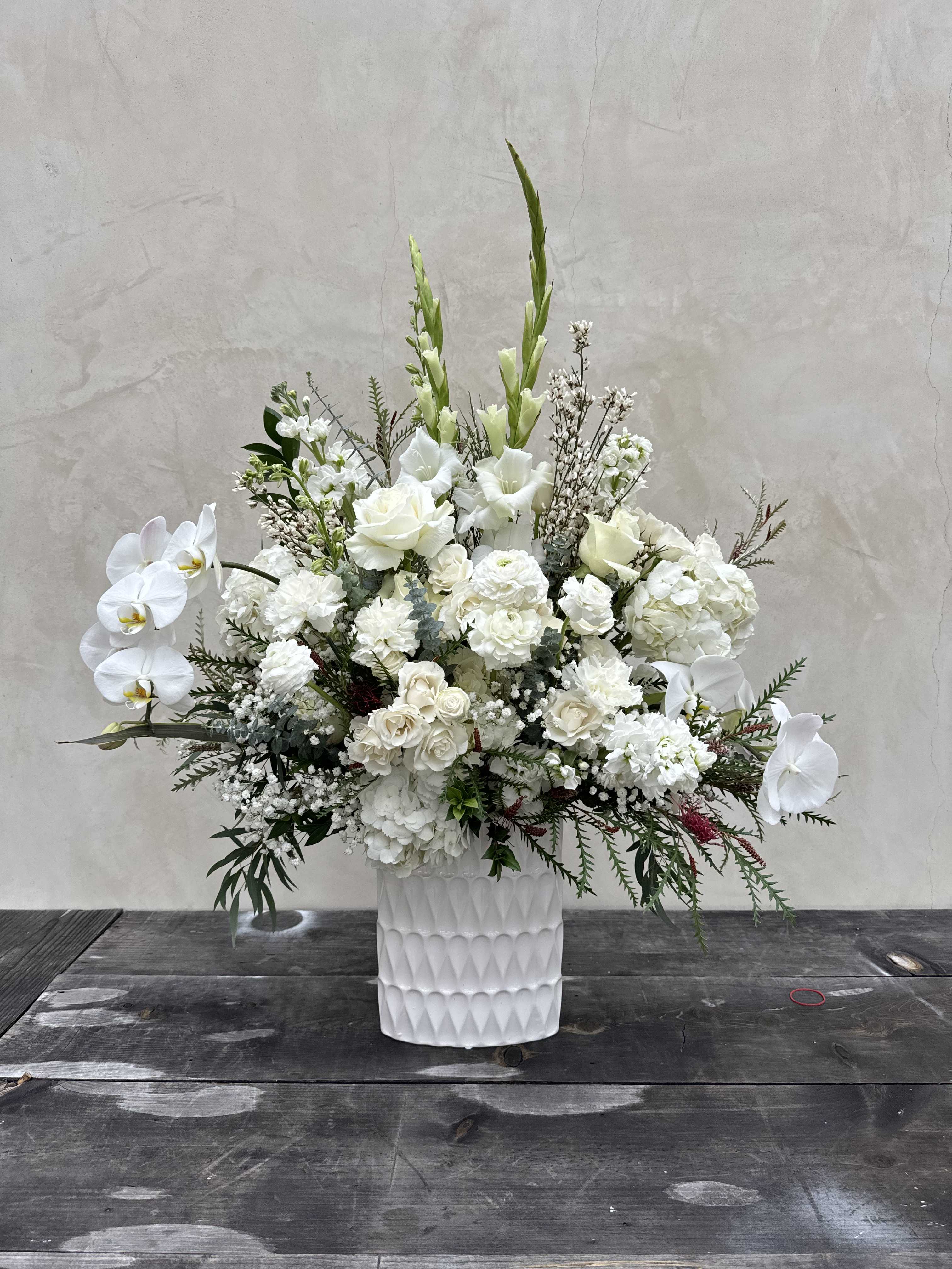 White Mist - All white florals which includes white roses, white spray roses, white orchids, white ranunculus, babysbreath, white hydrangea, and more