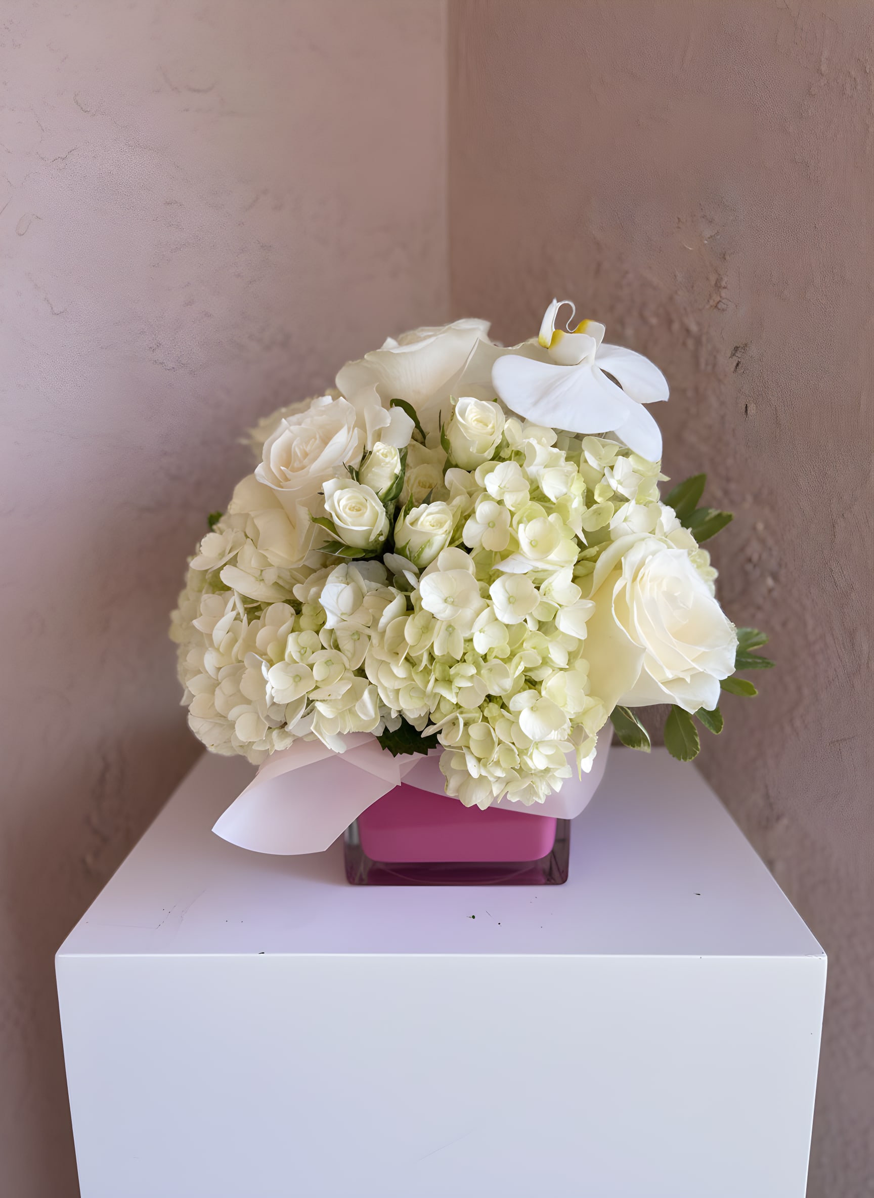 Cloud Nine - An elegant all-white arrangement featuring hydrangeas, roses, and orchid accents