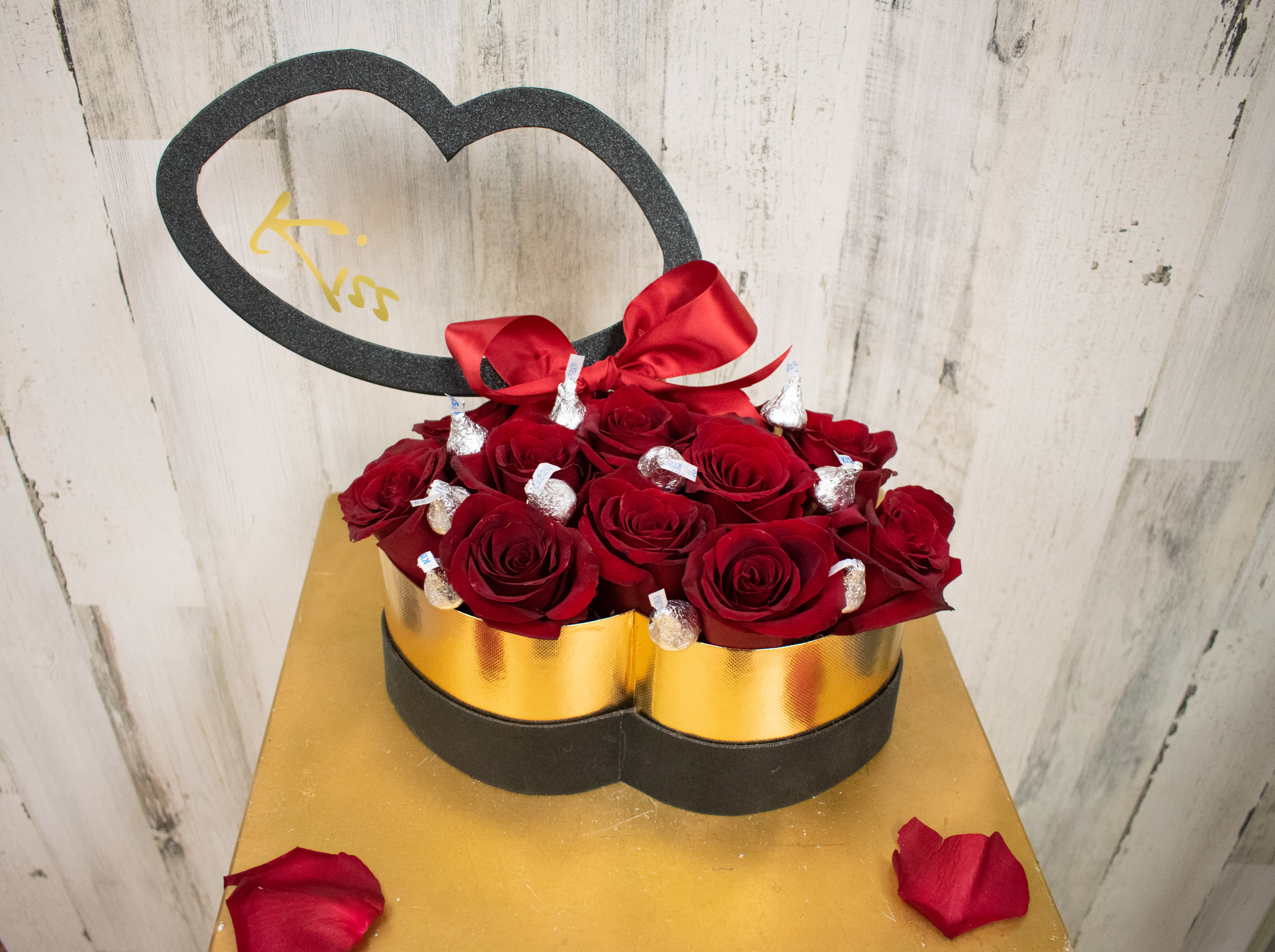 Sweet Kisses - Send a sweet kiss! One dozen red roses with milk chocolate Hershey’s kisses in between. Box available in gold black and red. Please specify in special instructions section for rose color change. 