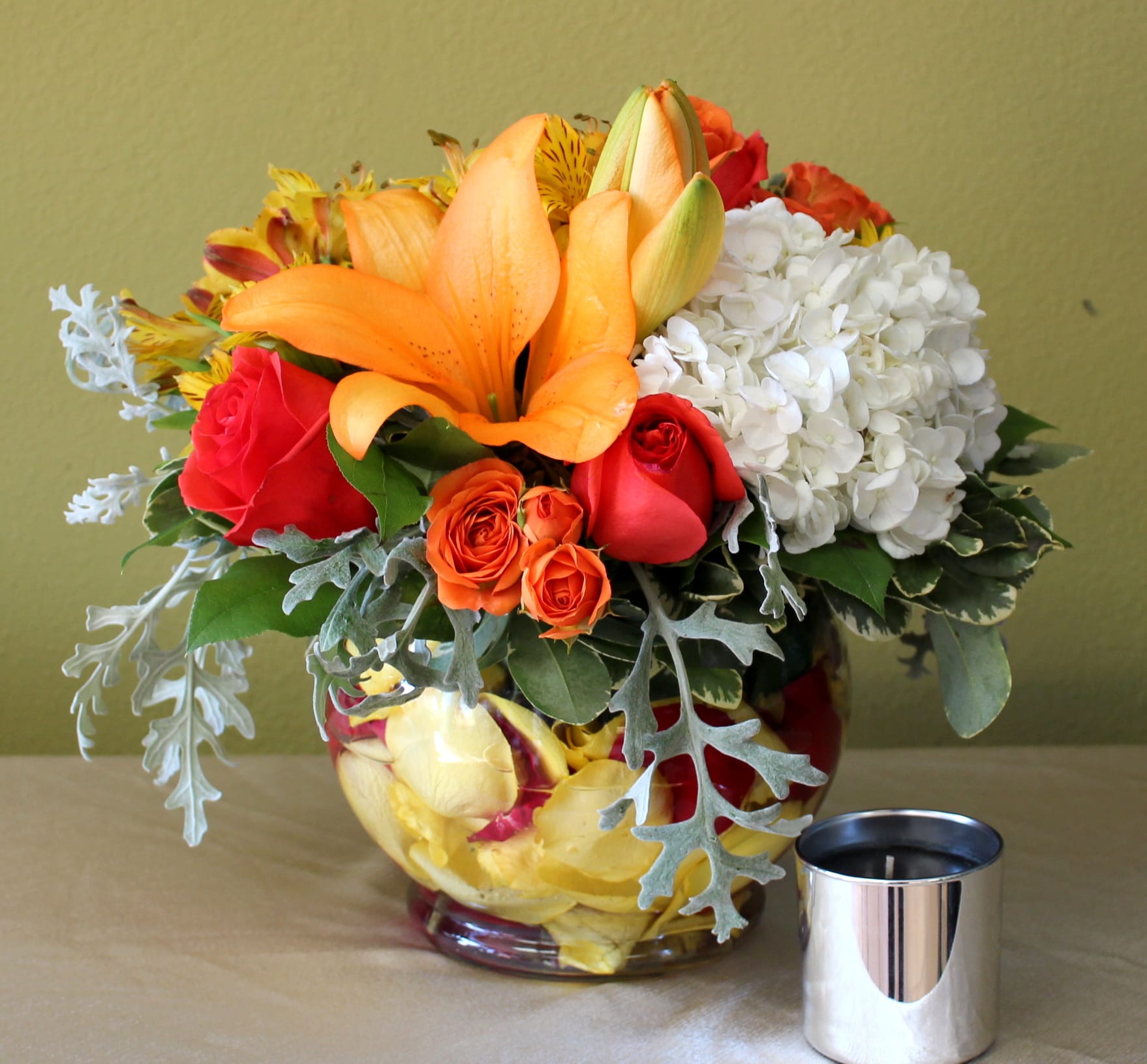 Cheerful bubble bowl  - bubble bowl clear with red and yellow rose petals inside, orange lily's, red roses, yellow astromerias, spray roses and white hydrangea