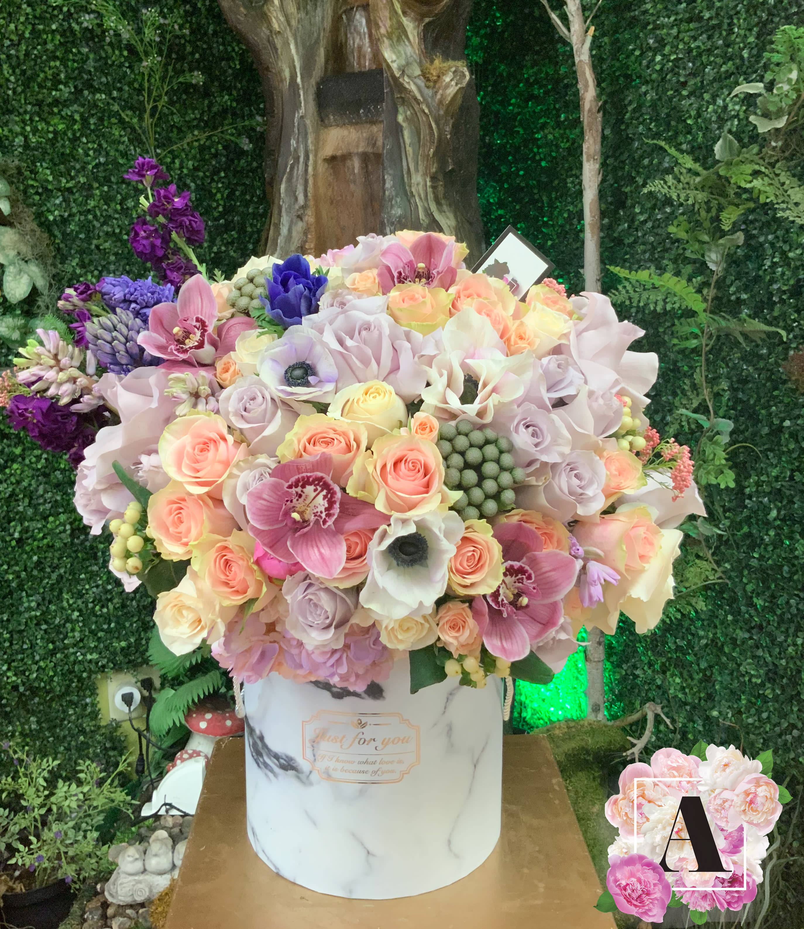 Lavender Dreams Hat Box - Flowers will come in lavender shades with seasonally available flowers. 