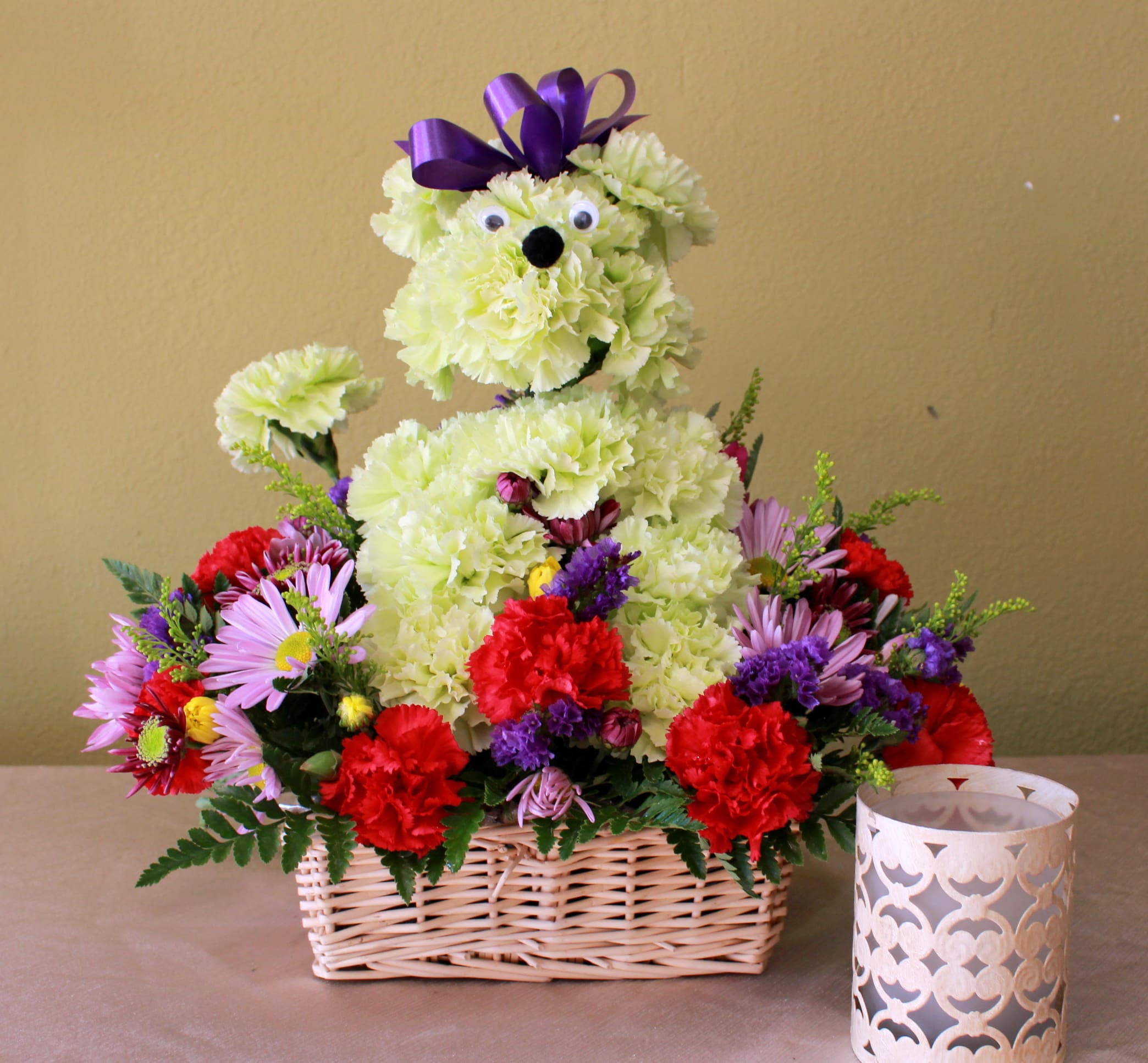 puppy love  - puddle made with carnations sitting on a garden of daisy's and carnations in a basket   