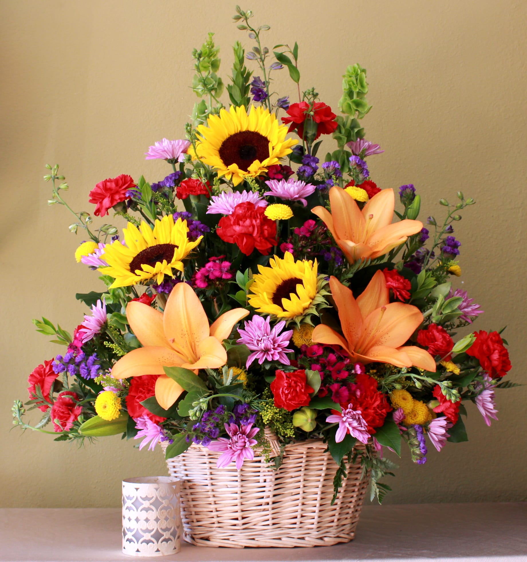 Basket arrangement with sunflowers, lilies, and mixed blooms