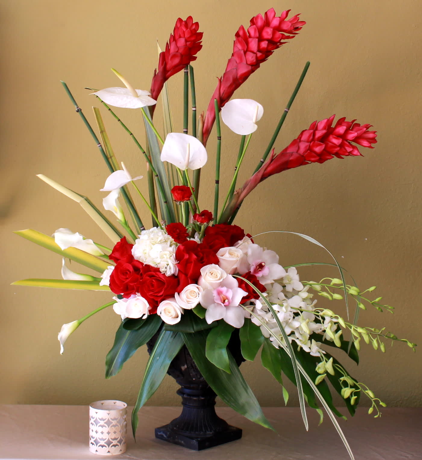 Sweet and Sassy - Red and white Tropical arrangement with ginger, anthuriums ,calla lily's ,red and white roses and orchids in a tall ceramic container 