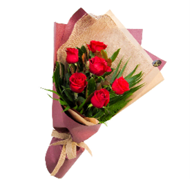 Bouquet of red roses wrapped in pink and tan paper