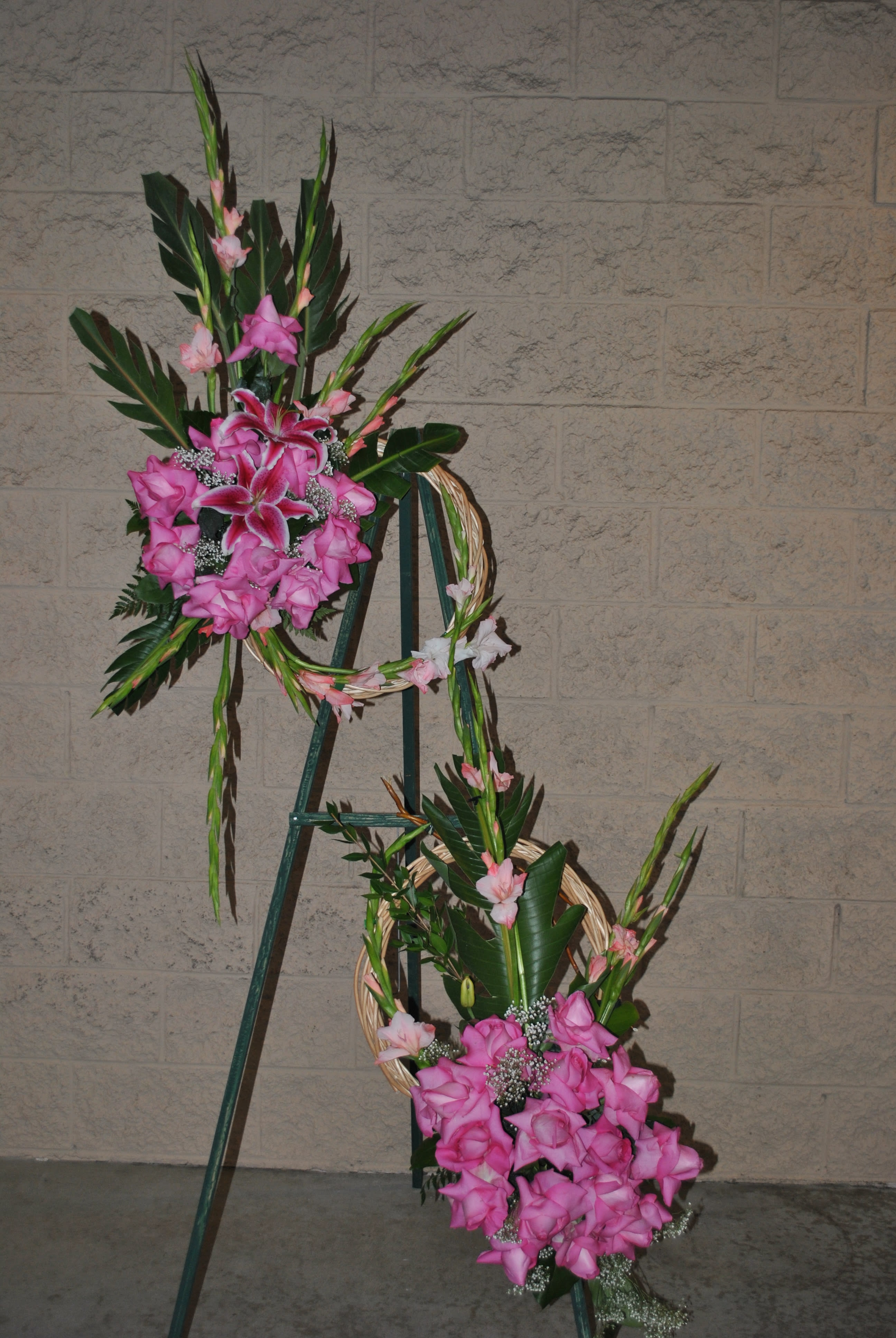 sympathy standing desing  - two in one sympathy arrangement on a easel. pink roses with stargazers and gladiolus.