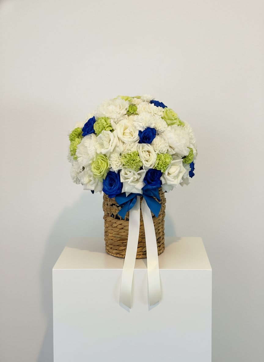 Blue Belle Basket - Classic white blooms paired with royal blue roses in a woven keepsake basket.