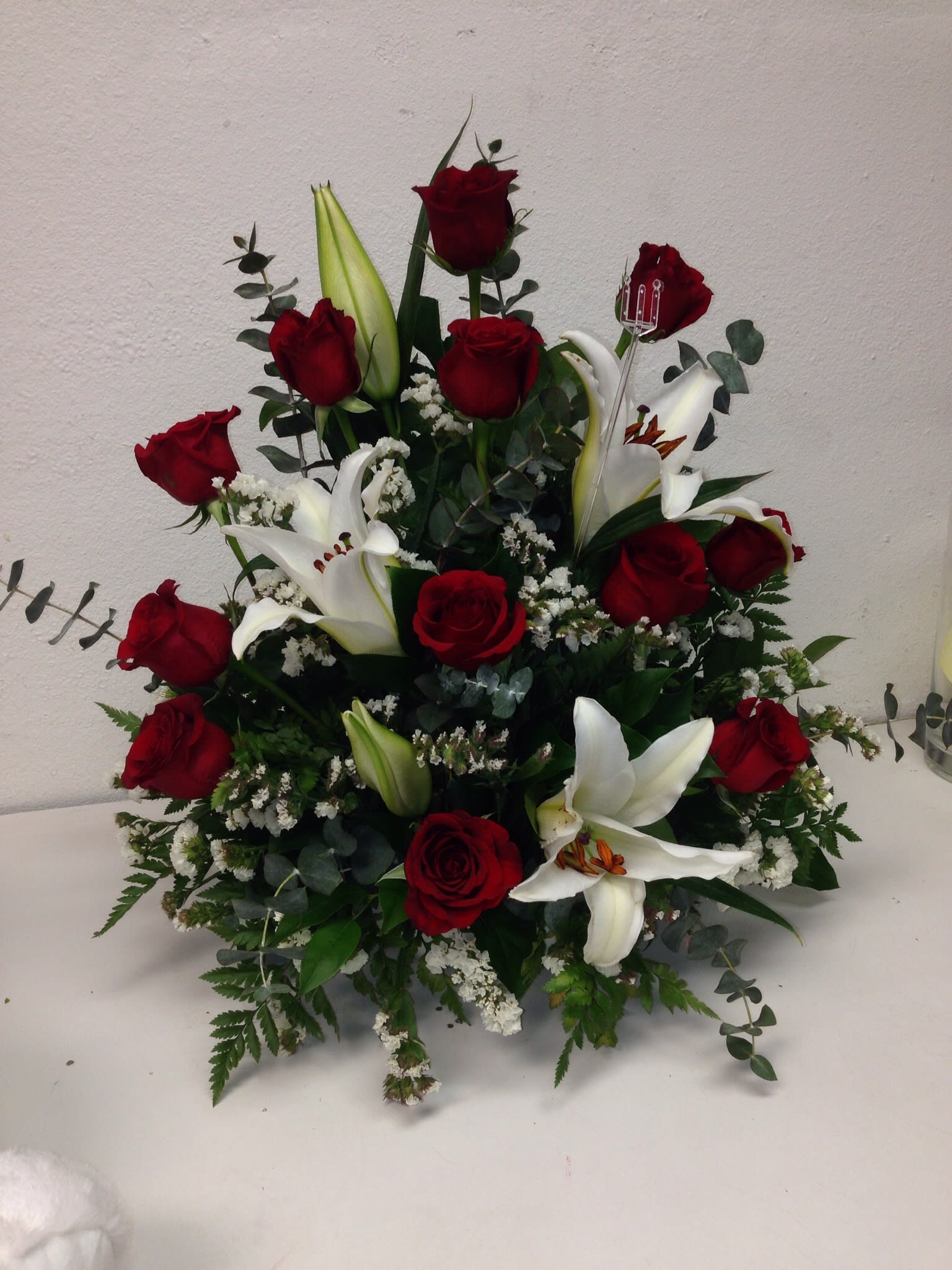 One dozen roses in any color with Lilly's  - One dozen roses with Lilly's. Deluxe 18 roses and Lilly's. Premium 24 roses and lilys