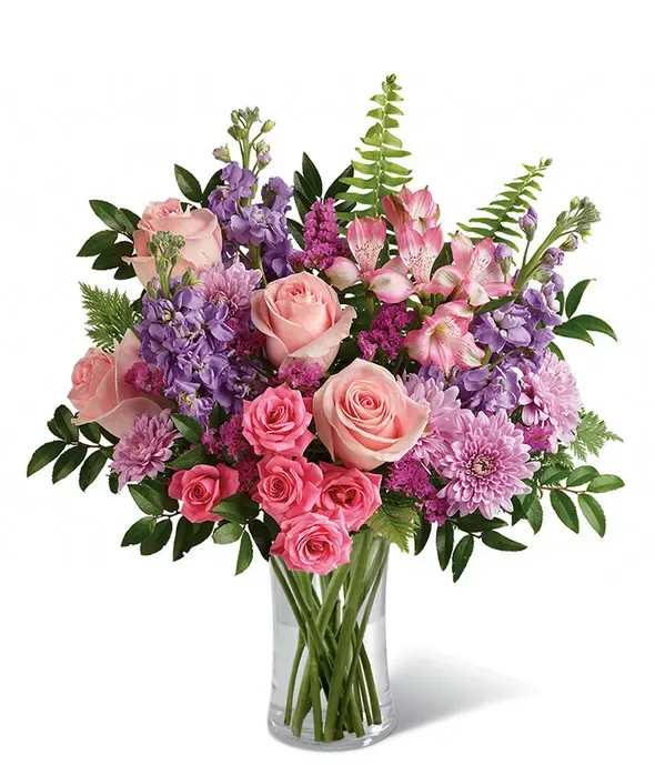 Pink and purple mixed bouquet in a clear glass vase