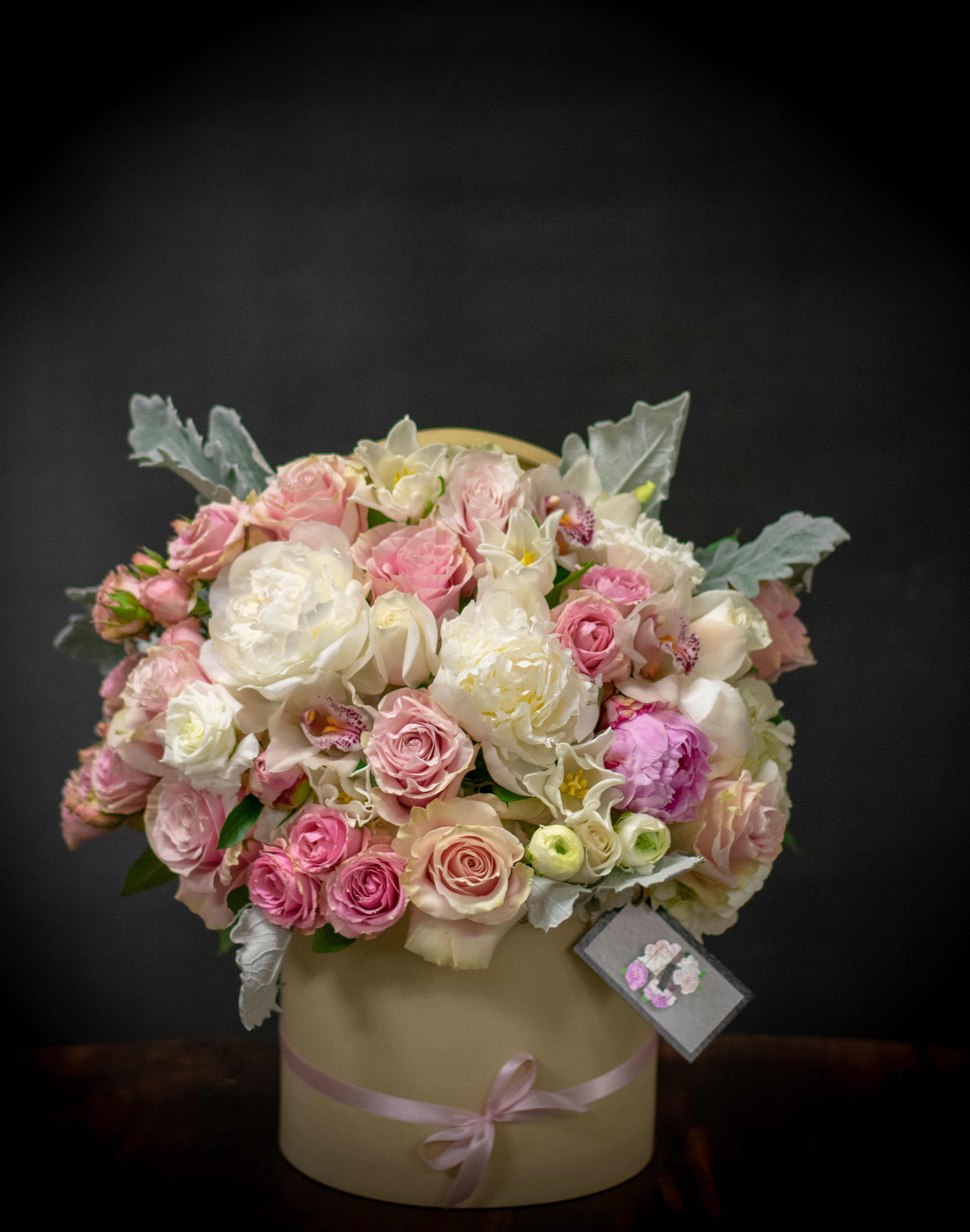 cream hat box  - our mode design has pink roses,dusty miller fillers mini roses peonies and other assortment of high end flowers  