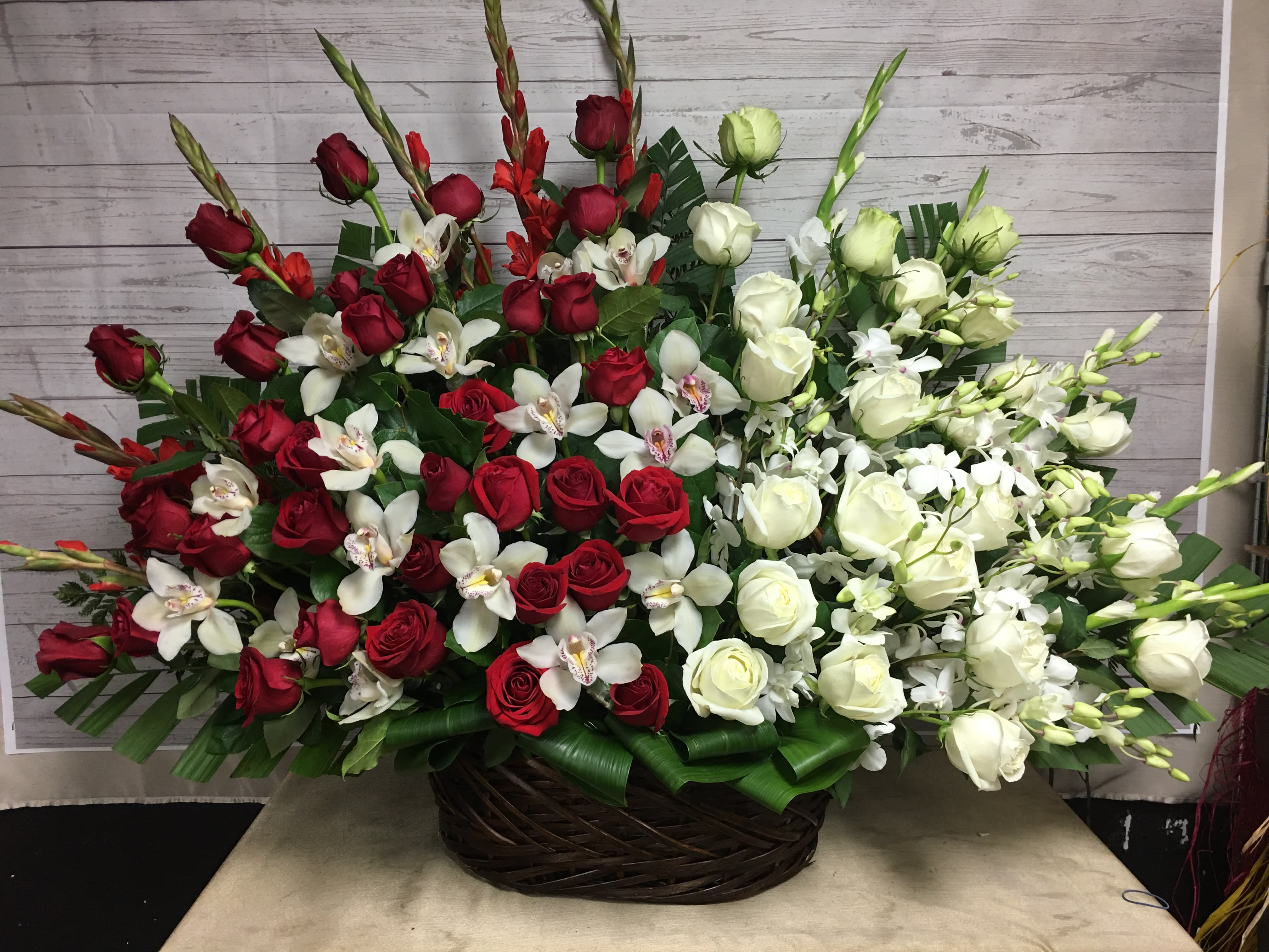 LOVED BY YOU BASKET - 25 red roses 25, white dendro orchids, white cymbidium orchids, and gladiolus. Very grand and beautiful, sure to wow for any occasion. 