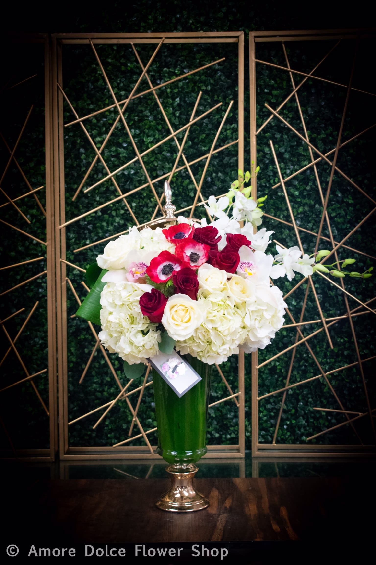 Elegant Keepsake Container Arrangment - A mix of seasonal flowers including roses and hydrangeas arranged in a keepsake glass container with a metal lid. 
