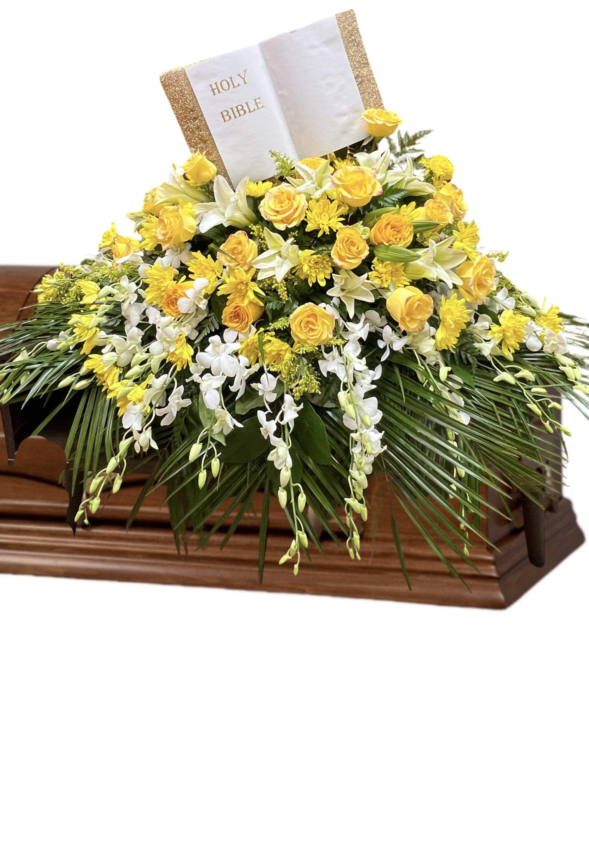 Yellow and white floral casket spray with a Holy Bible card
