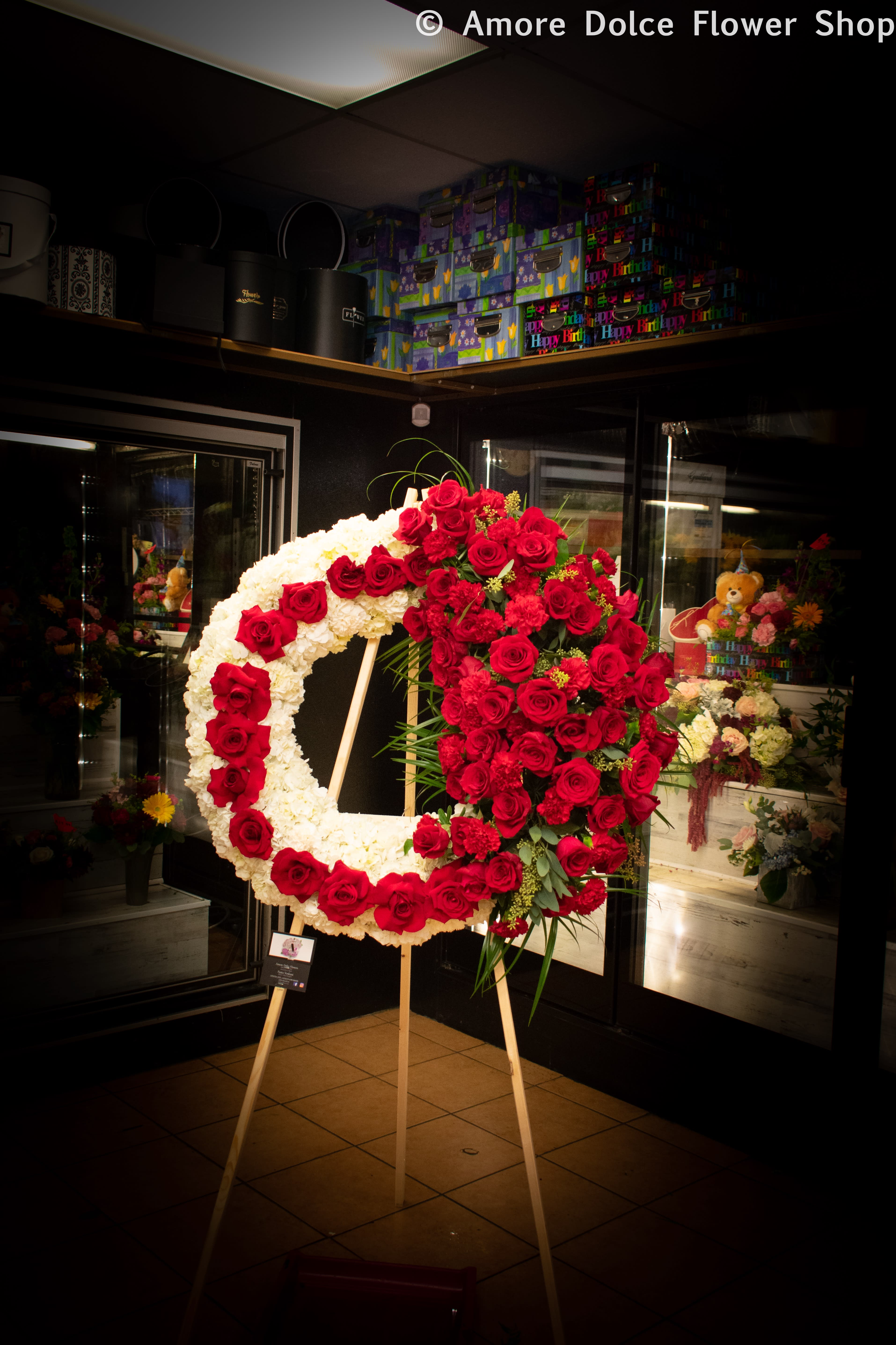 Heavenly Halo Wreath  - Standard size is 27’’ the body or the wreath is hydrangea and the large cluster of flowers include large Ecuadorian red rose, carnations, and eucalyptus leaves. Please let us know what you would like to write on the banner in the special instructions section. Make sure to include the name of the deceased along with time of viewing.         Flower delivery montebello ,Whittier,Pasadena,Downey,Pico Rivera,la habra,downtown ,los angles 
