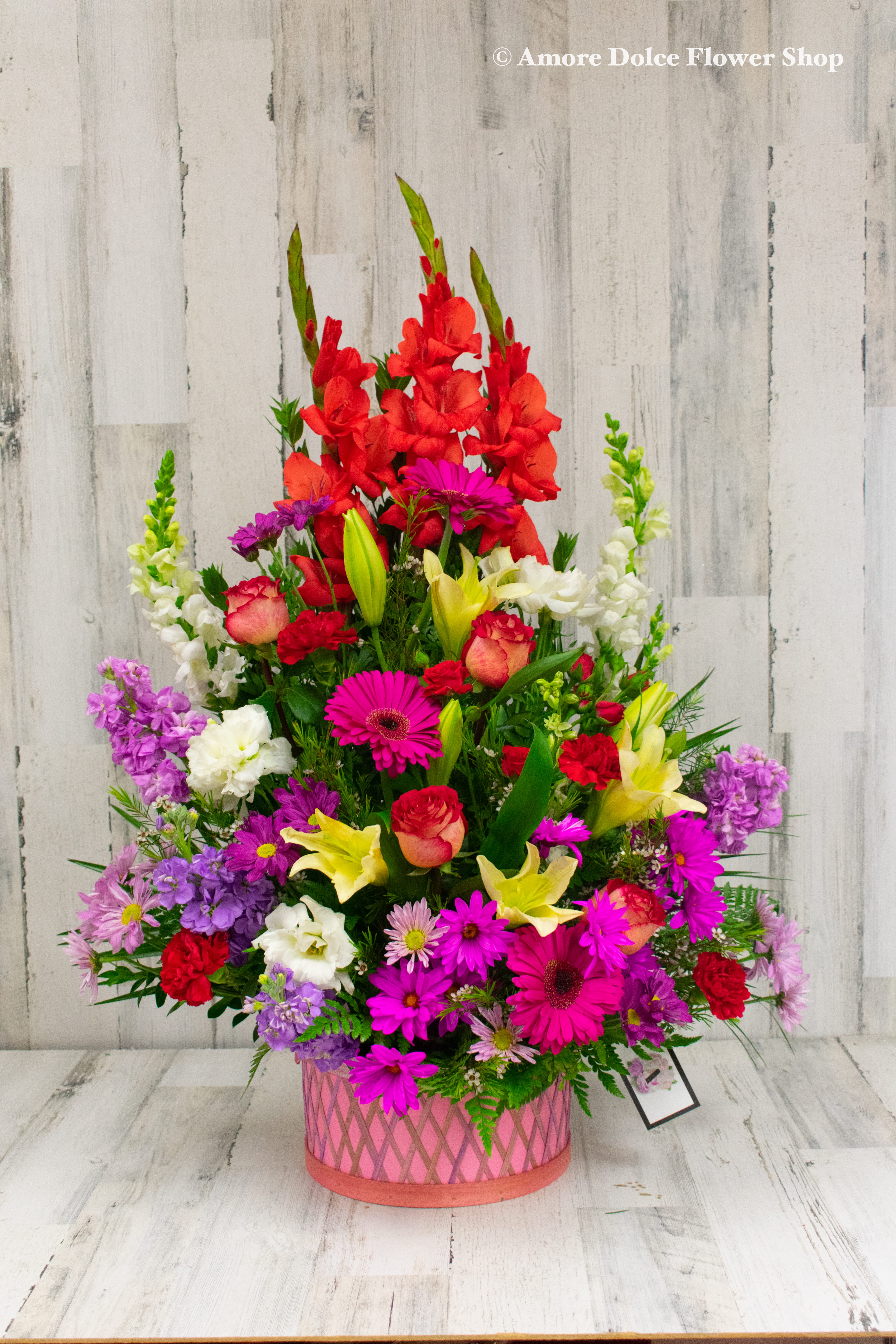 Brighter Days - Bright, happy, cheerful colors of spring flowers arranged in a basket. Arrangement will come approximately as shown.