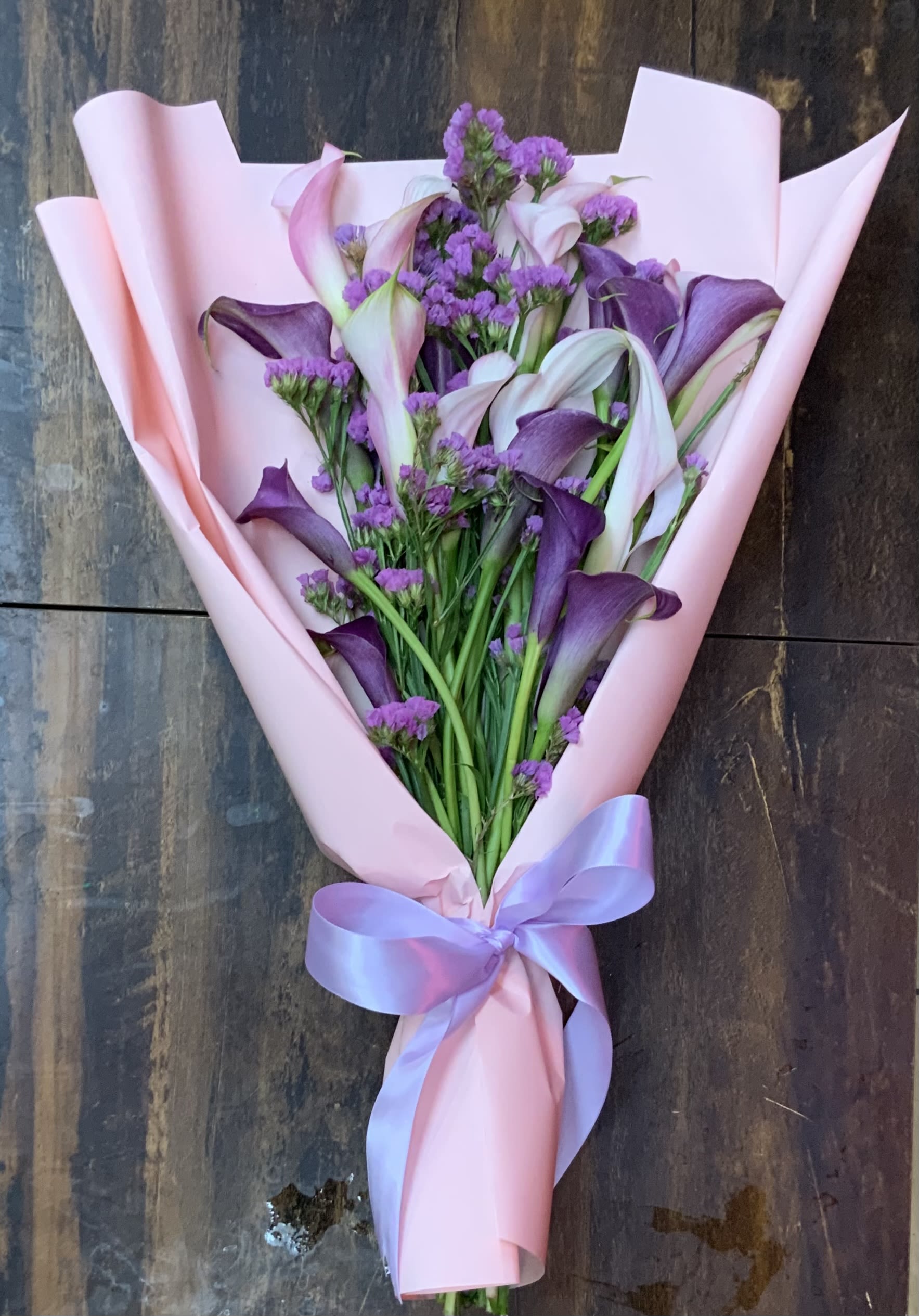 Calla Lily Crazy - Two mixed color Cala lilies to equal 20 stems of mini Cala lilies in each bouquet with filler accents in this beautifully wrapped bouquet for anyone who is Cala lily crazy! Color variations may vary depending on availability. A photo will be sent for approval before delivery. (with the exception of Mother Day or Valentin'es Day