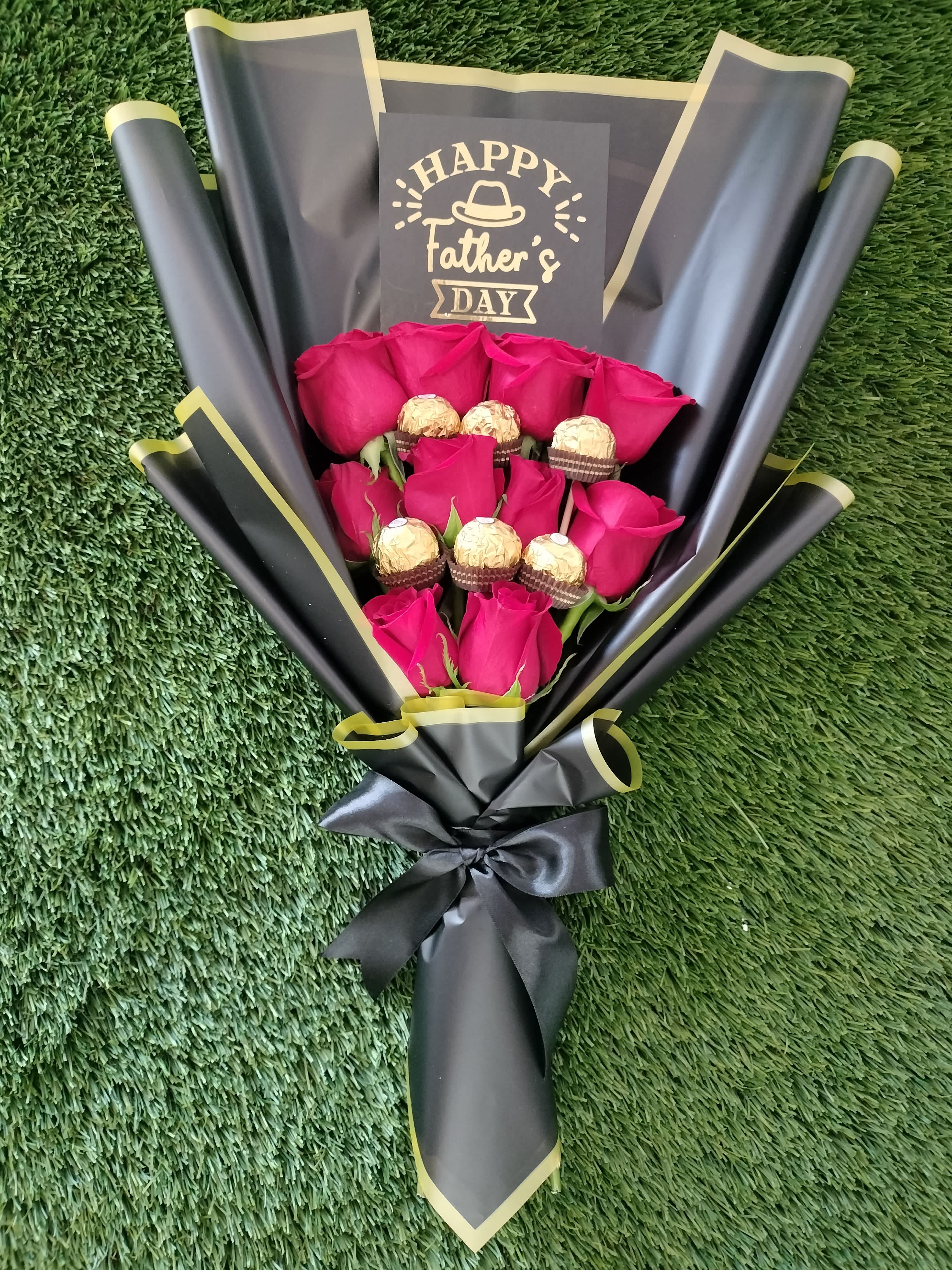 Bouquet of pink roses with chocolates and a Father’s Day card