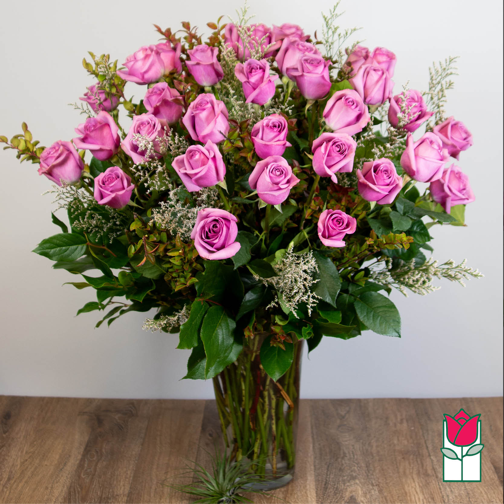Pink roses arranged in a clear glass vase