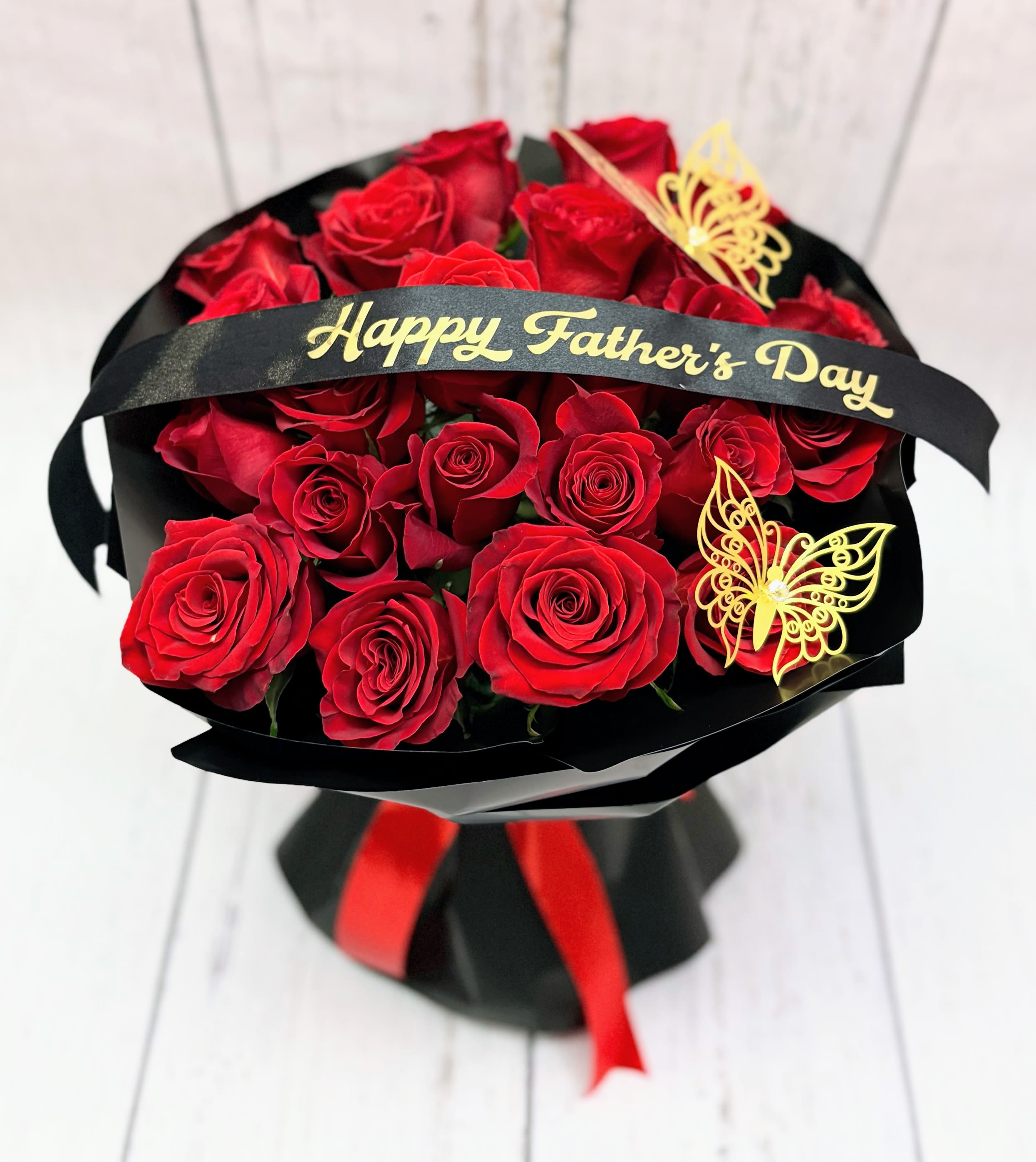 Bouquet of red roses with a Happy Father's Day ribbon