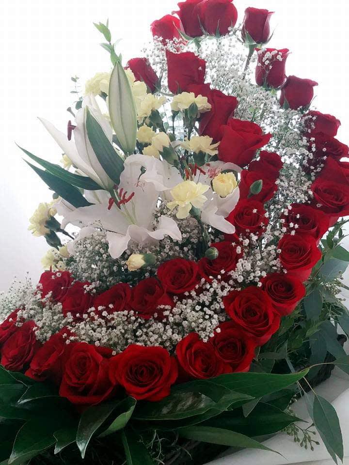 Red roses and white lilies arranged with baby's breath