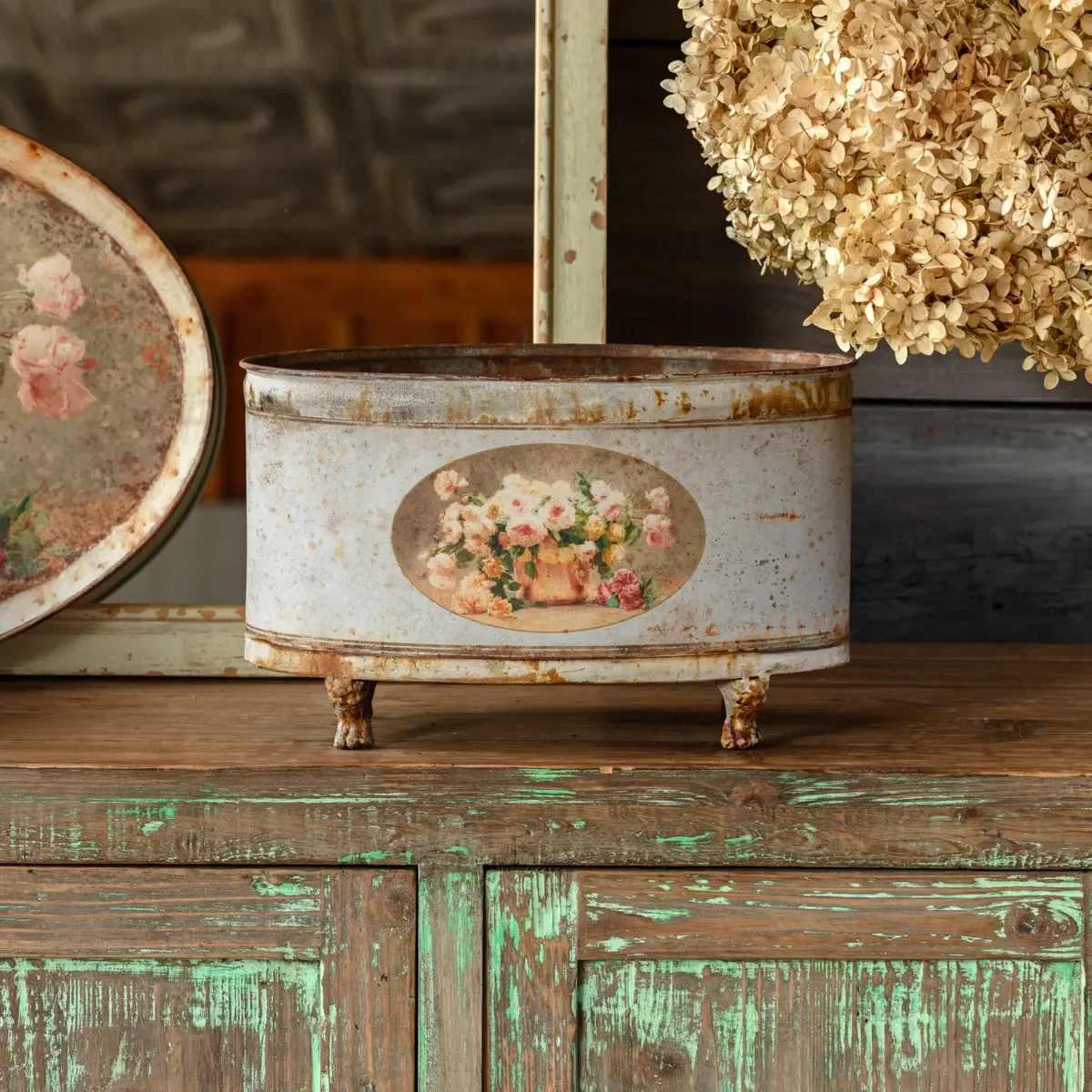 Old Rose Oblong Tole Container - The Old Rose oblong Tole container has a perfectly aged finish. Elegant cut gathered roses make you almost smell their sweet scent. Filled with live plants or just left alone will elevate your design style.