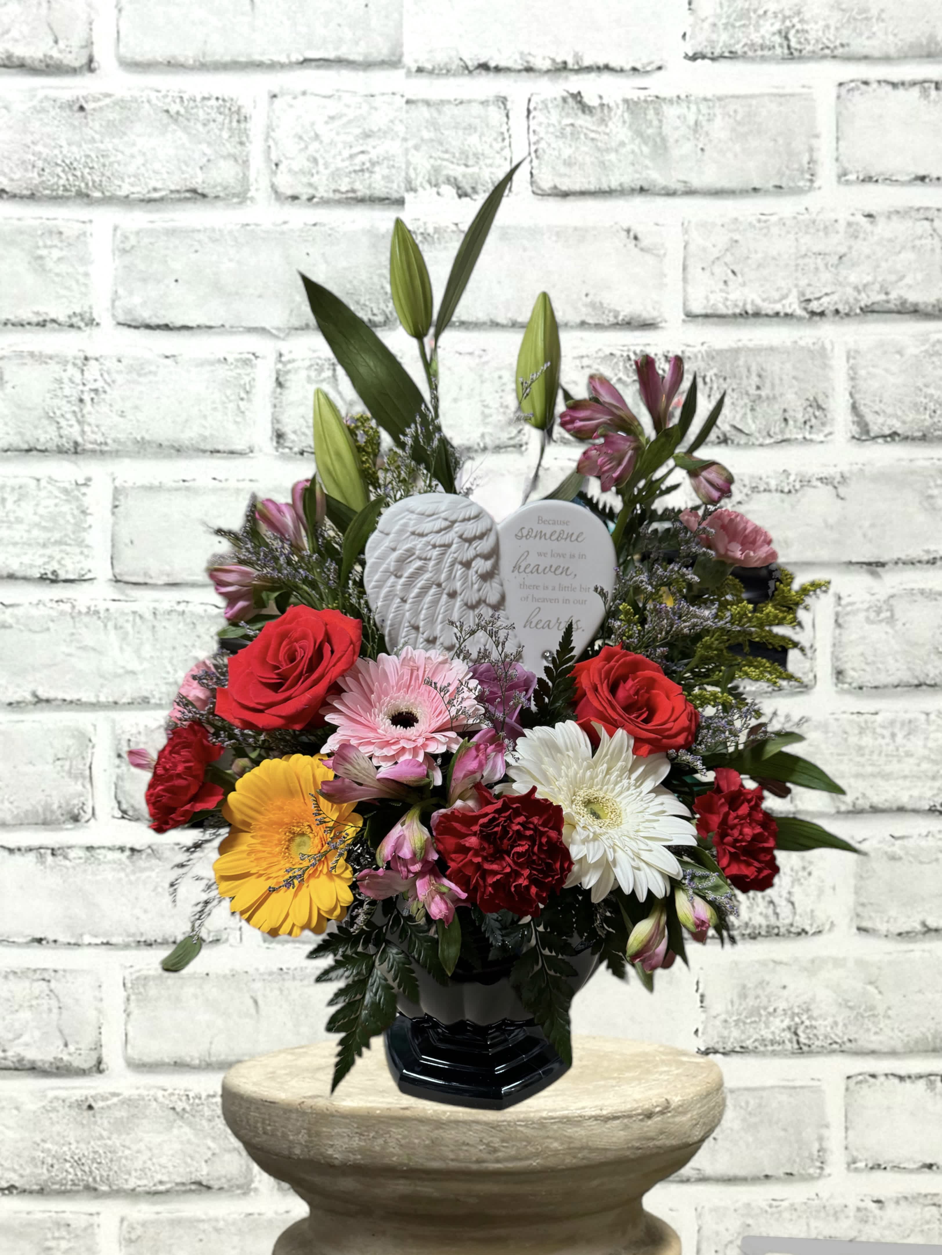Someone in Heaven Tribute colorful AF113 - "Because someone we love is in heaven, there is a little bit of heaven in our hearts." A mixture of seasonal flowers combine to make a beautiful tribute.