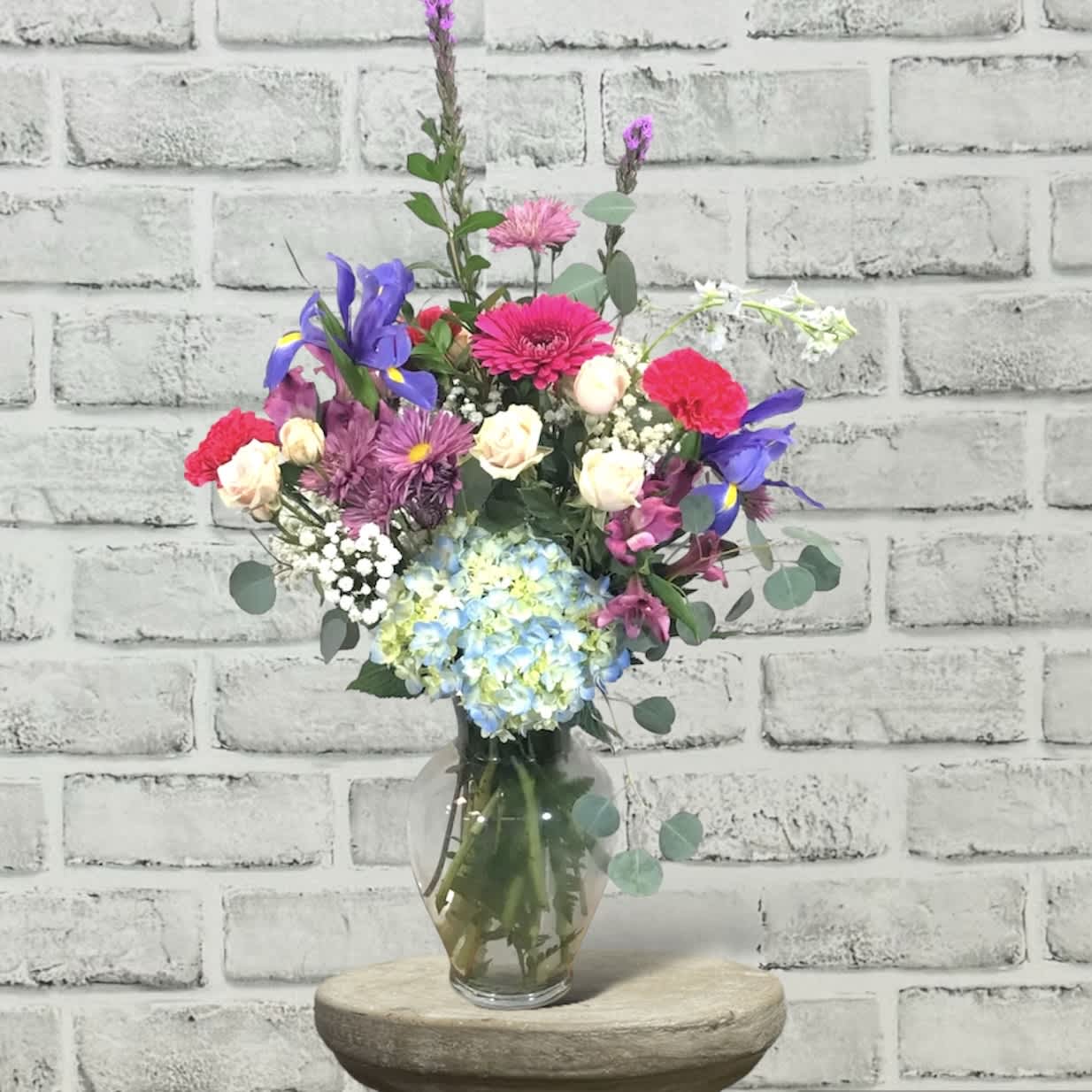 Frist Love FG222 - This traditional design in a vase has beautiful flowers in colors of spring.  It include both roses and spray roses.    Approximately 27" H x 18" W.
