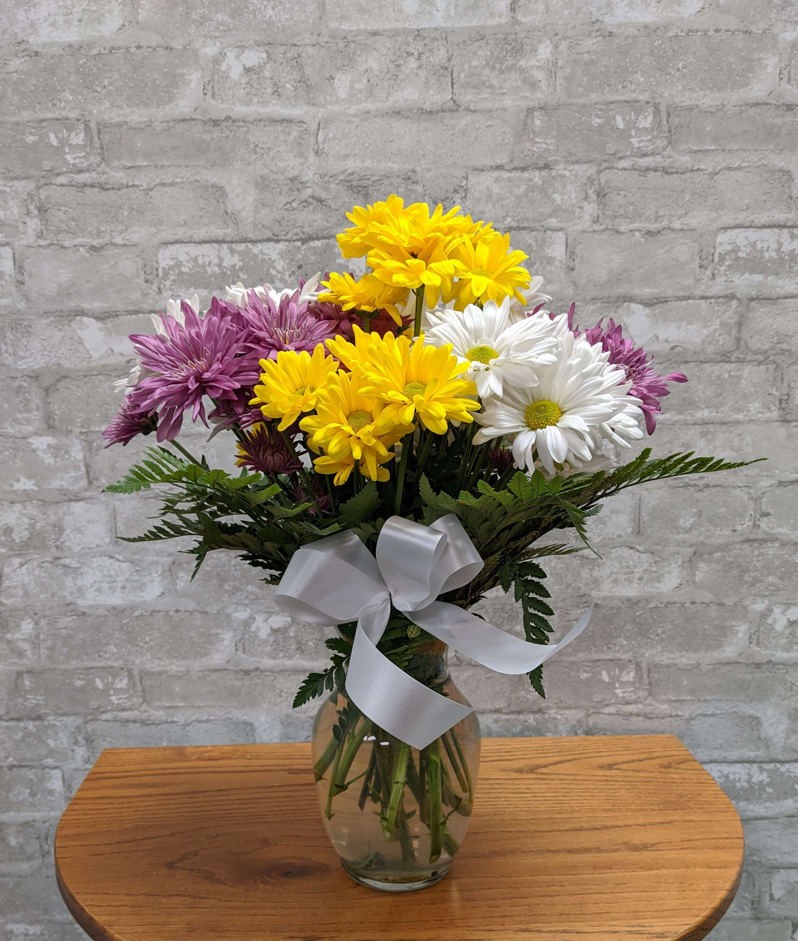 Painted Daisies FG212 - Marvelously cheerful design of bright colorful daisies featured in a petite vase.  Approximately 18" H and 12" W.