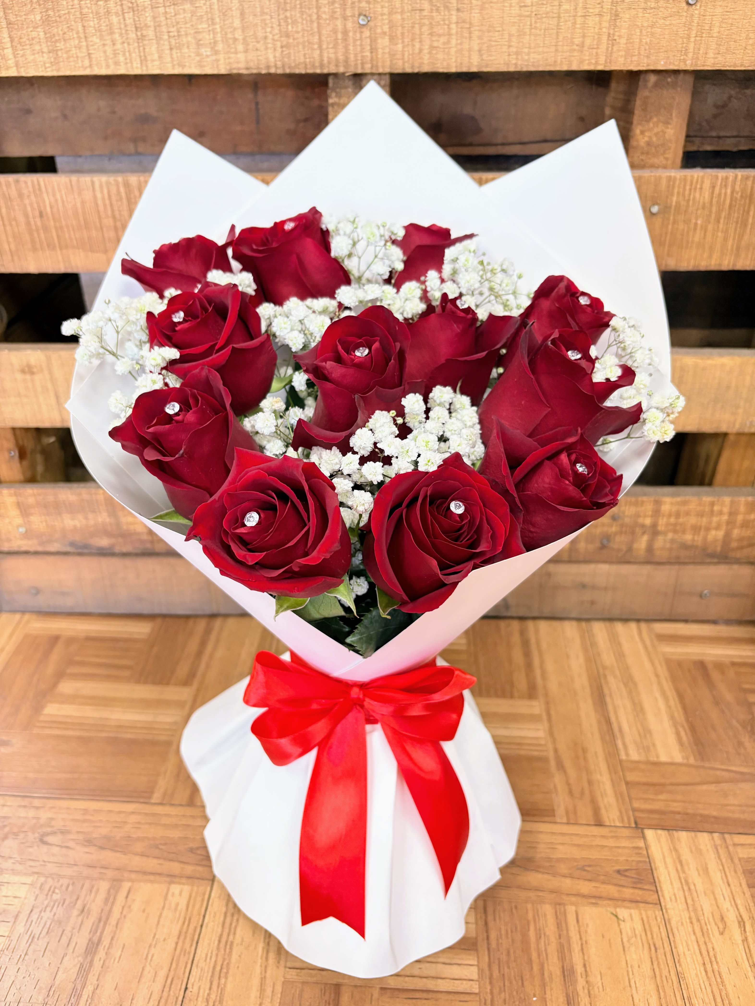 Bouquet of red roses with white baby's breath and a red ribbon