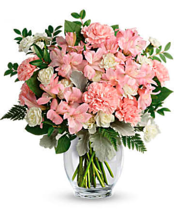 Pink and white bouquet in a clear glass vase