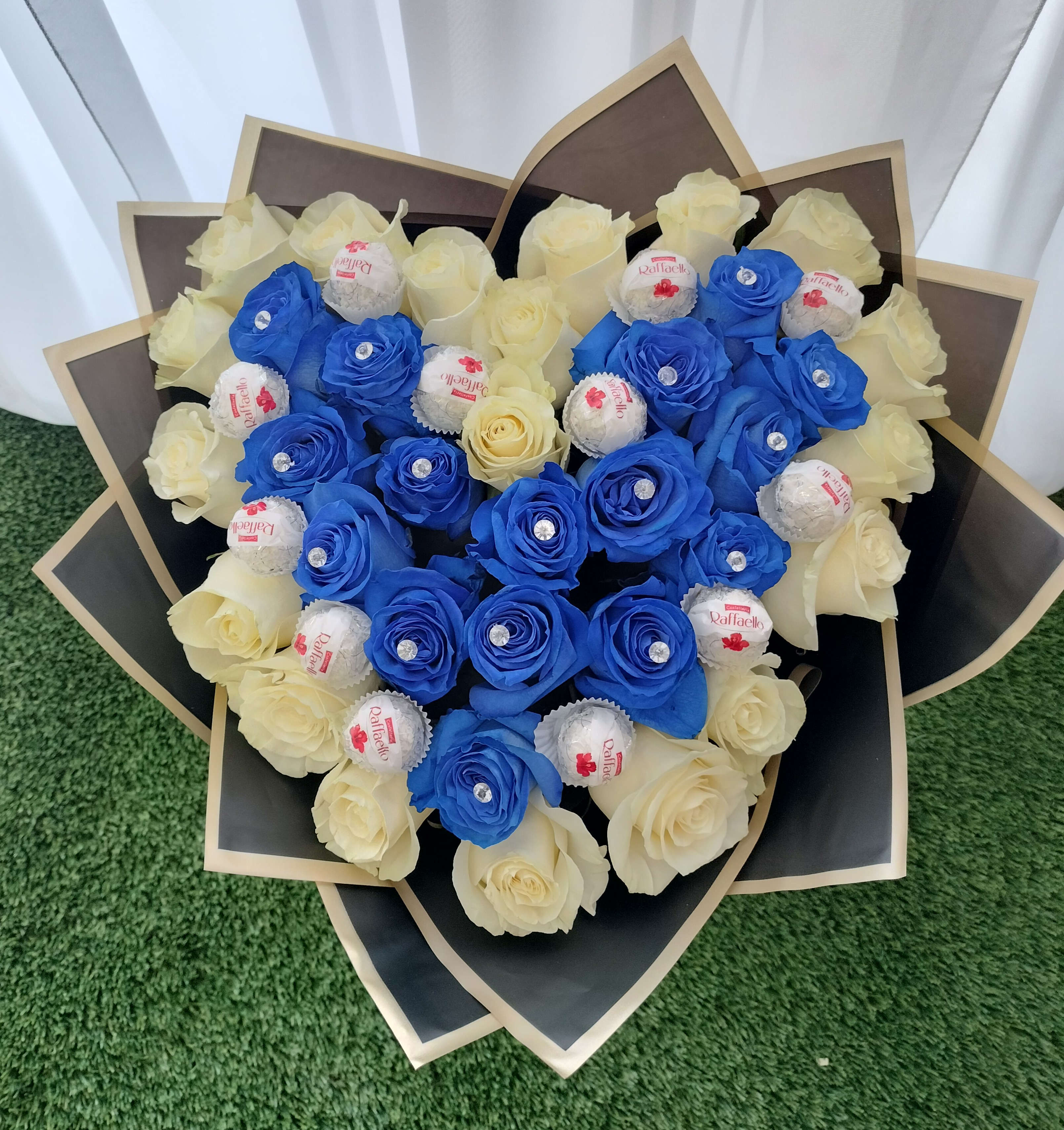 Bouquet of blue and cream roses with Raffaello chocolates